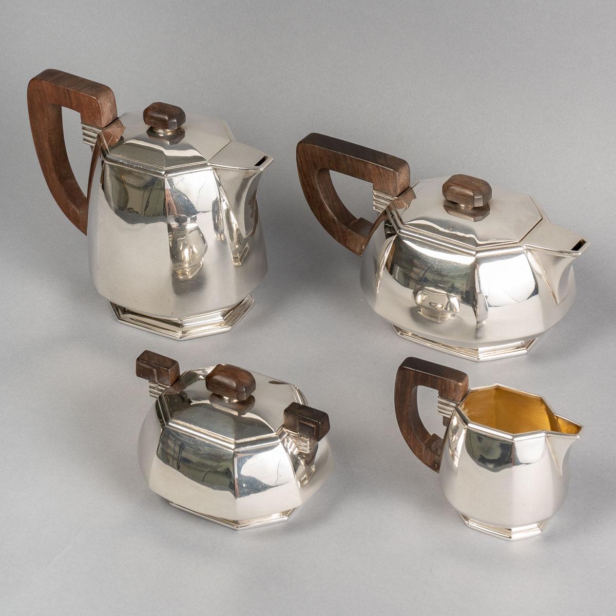 Art Deco Modernist tea and coffee service with cut sides in sterling pure silver and rosewood sockets by Puiforcat created in the 1930s.

Service comprising:
- a coffe pot of 16 cm x 19 cm 
-  a teapot of 11,5 cm x 22,5 cm 
- a milkpot of 10 cm x 12
