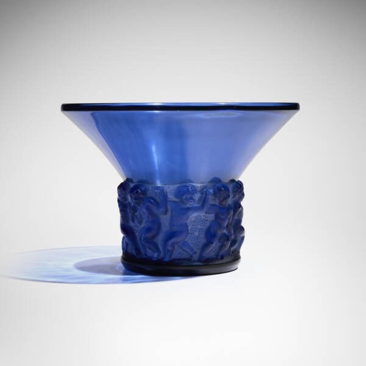Molded, pressed, blue-tinted glass vase.

Model created by René Lalique in 1930, discontinued in 1937.

Bibliography: René Lalique, Les œuvres de René Lalique, by Félix Marcilhac.