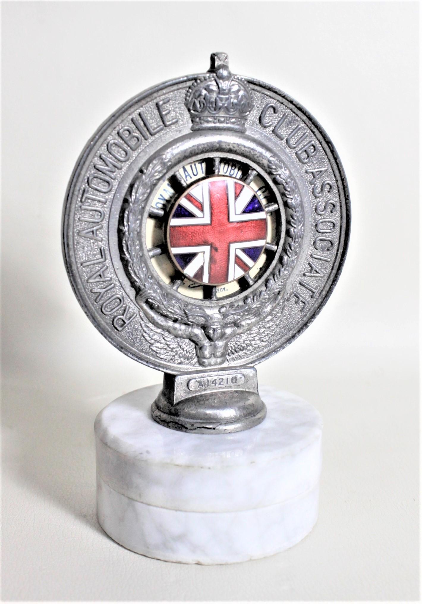 This Royal Automobile Club Associate car badge was made by the Patent Die Assoc. Co. of London in presumably 1929 in London England in the period Art Deco style. The badge is composed of cast metal which has an enamel Union Jack in the center area