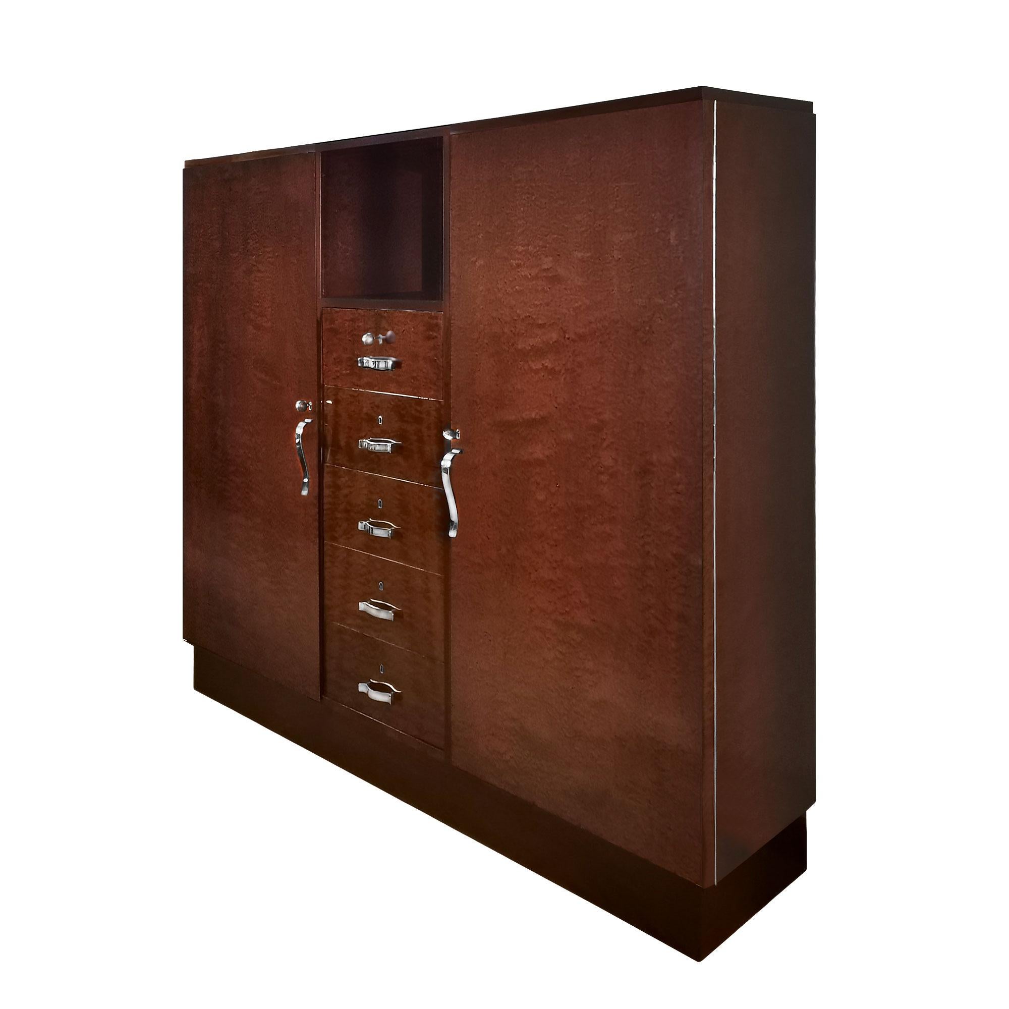 Art Deco bookcase, beech and blond mahogany structure with mottled mahogany veneer. Central block with five drawers with doors on each side with five shelves each, french polish. Nickel plated brass hardware. Can be completely dismantled.

Spain,