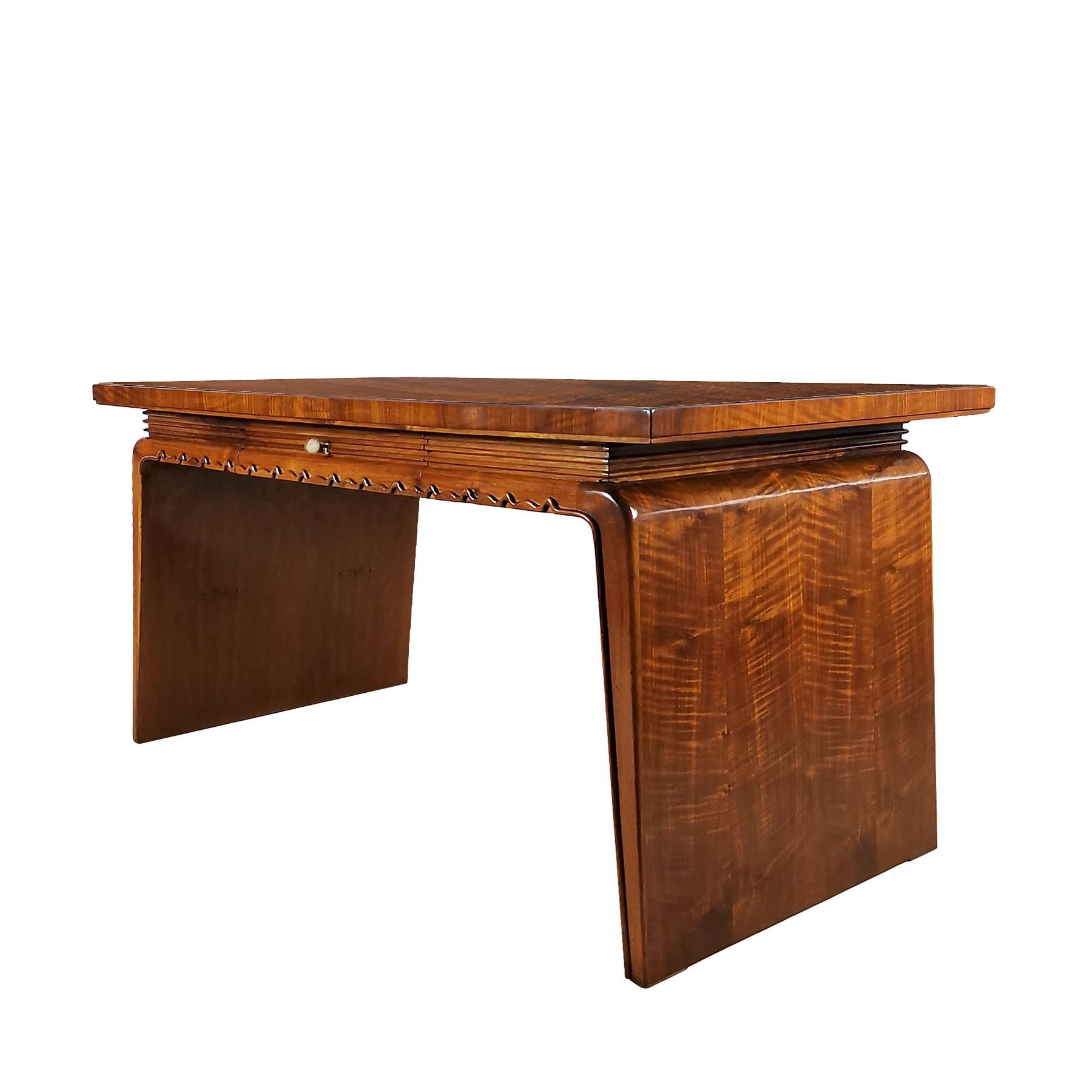 Art Deco flat desk with one-drawer, beech structure with walnut veneer. Japanese inspired base with a solid walnut undulant moulding as the encircled base of top and drawer, French polish.

Italy, circa 1930.