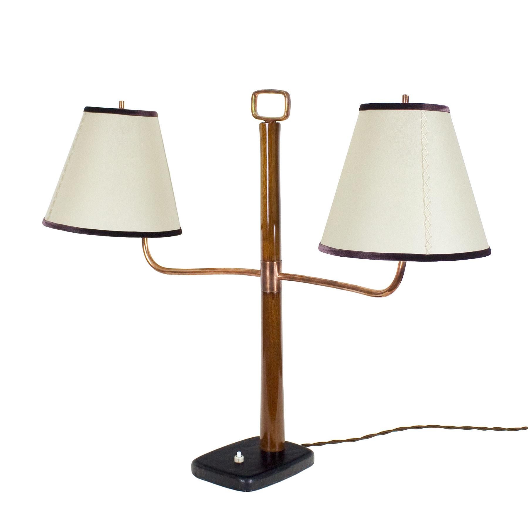 Art Deco library table lamp, solid mahogany, French polish, steel base covered with chocolate brown leather. Polished copper arms and handle, parchment and brown velvet lampshades.

Italy, circa 1930.