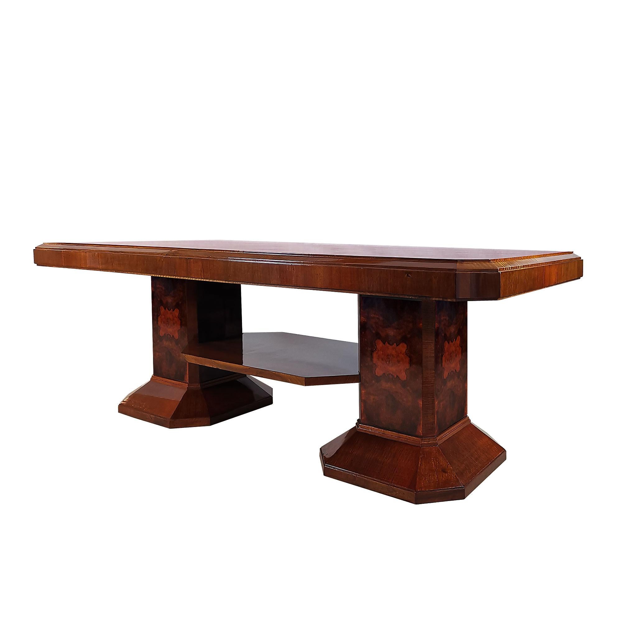 Large Art Deco meeting table, two column style stands connected with an horizontal strut, solid wood with walnut and burl walnut veneer, french polish. Can be dismantled.

Spain, Barcelona c. 1930.