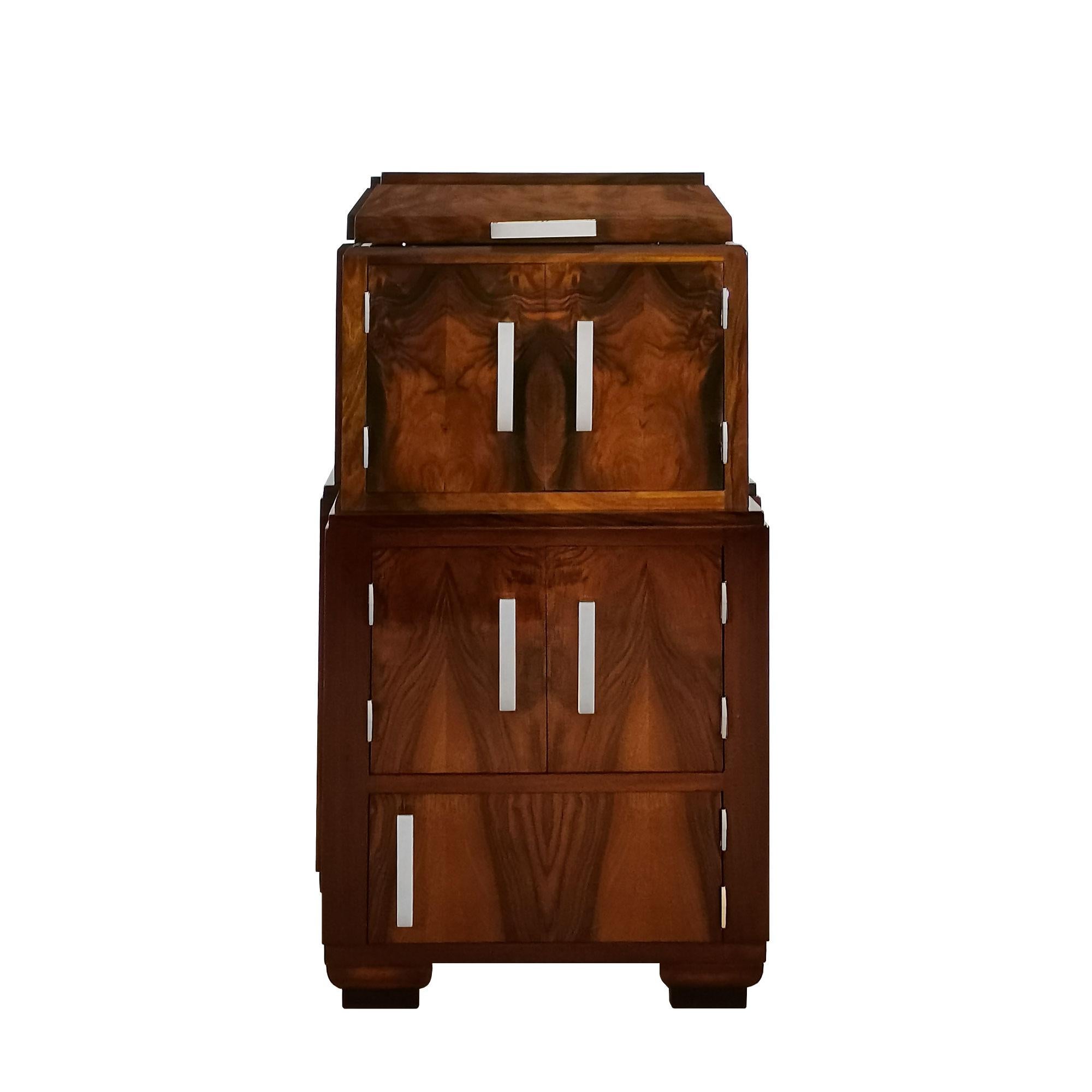 Art Deco radio cabinet converted into a dry bar or auxiliary cabinet, solid walnut and walnut veneer. Interior of the flap door decorated with marquetry. Three storage spaces in the front and two small niches on each side. French polish. Nickel