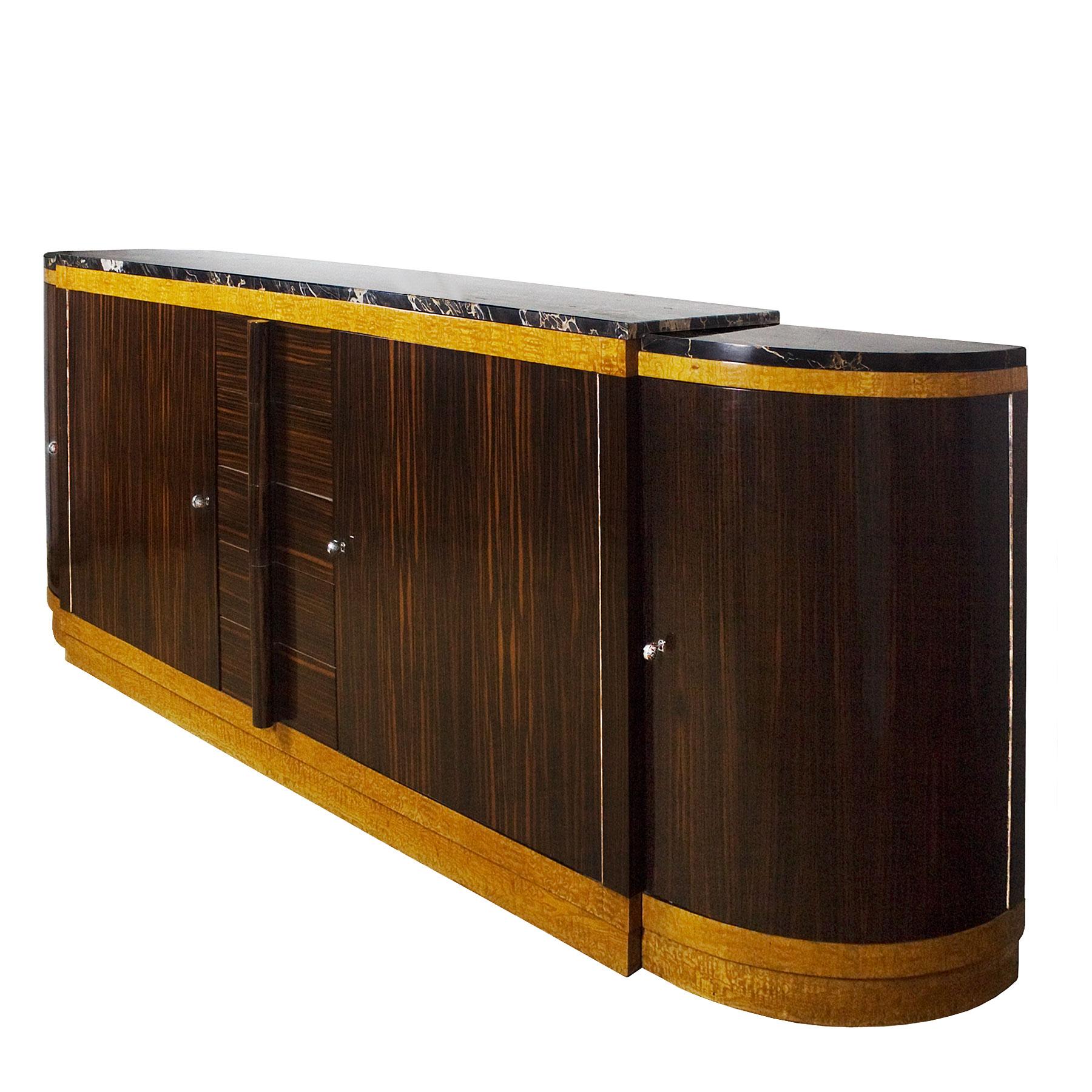 Spectacular large rounded Art Deco sideboard, oak structure with Macassar ebony and mottled maple veneer, French polish. Five drawers with solid Macassar ebony handles. Solid oak interiors and thick Portor marble on top in three pieces. Exceptional