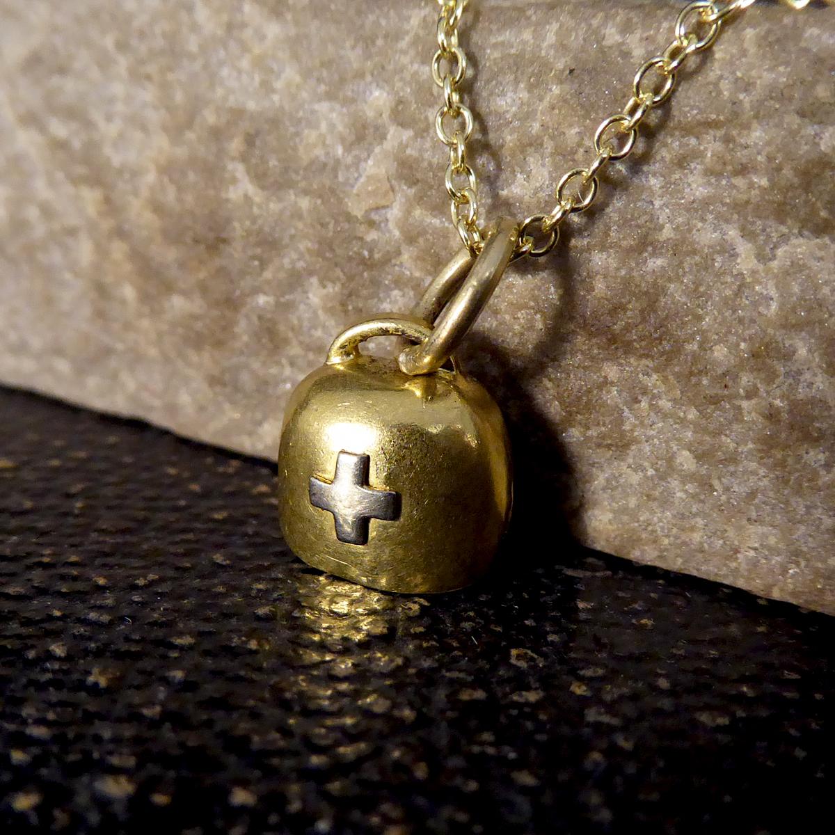 This lovely little antique charm was crafted with care in the 1930's from 15ct Yellow Gold with a White Gold cross on the front. This Swiss Cow Bell sits beautifully on the neckline on a contemporary 9ct Yellow Gold chain. A dainty and perfect