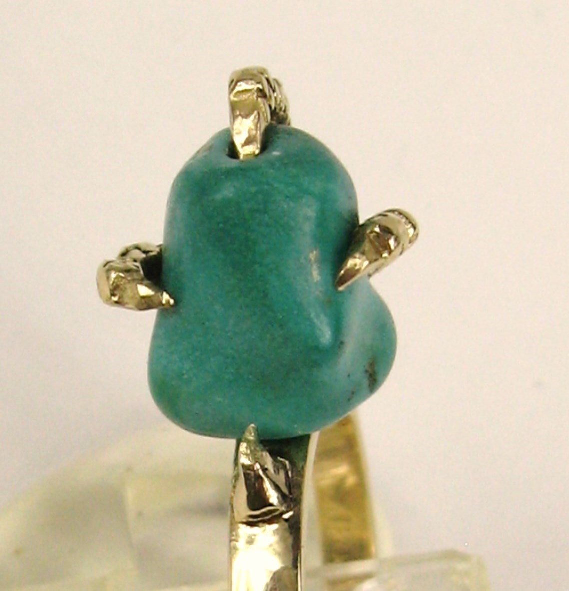 This stunning 18K gold Ring. With a griffin's talon holding tightly onto a chunk of Turquoise. Ring is a size 7.5 and can be sized by us or your jeweler. Sits up off your finger .62 inches. Please be sure to check out our massive selection of Fine