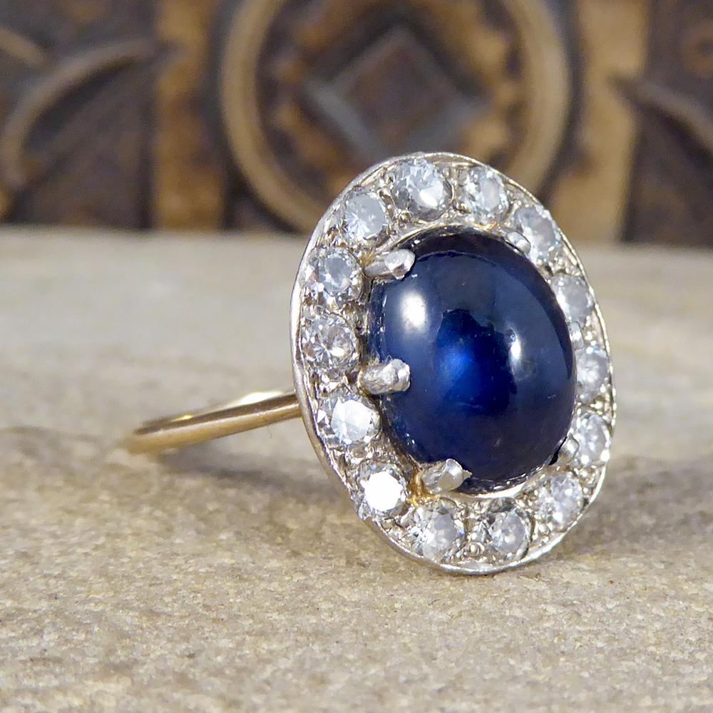 A gorgeous 4.07ct Cabochon Sapphire is at centre stage of this ring, with a deep blue mesmerising colour. Accompanying this beautiful stone are fourteen Diamonds weighing a total of 1.07ct with good colour and clarity. This ring has been set in
