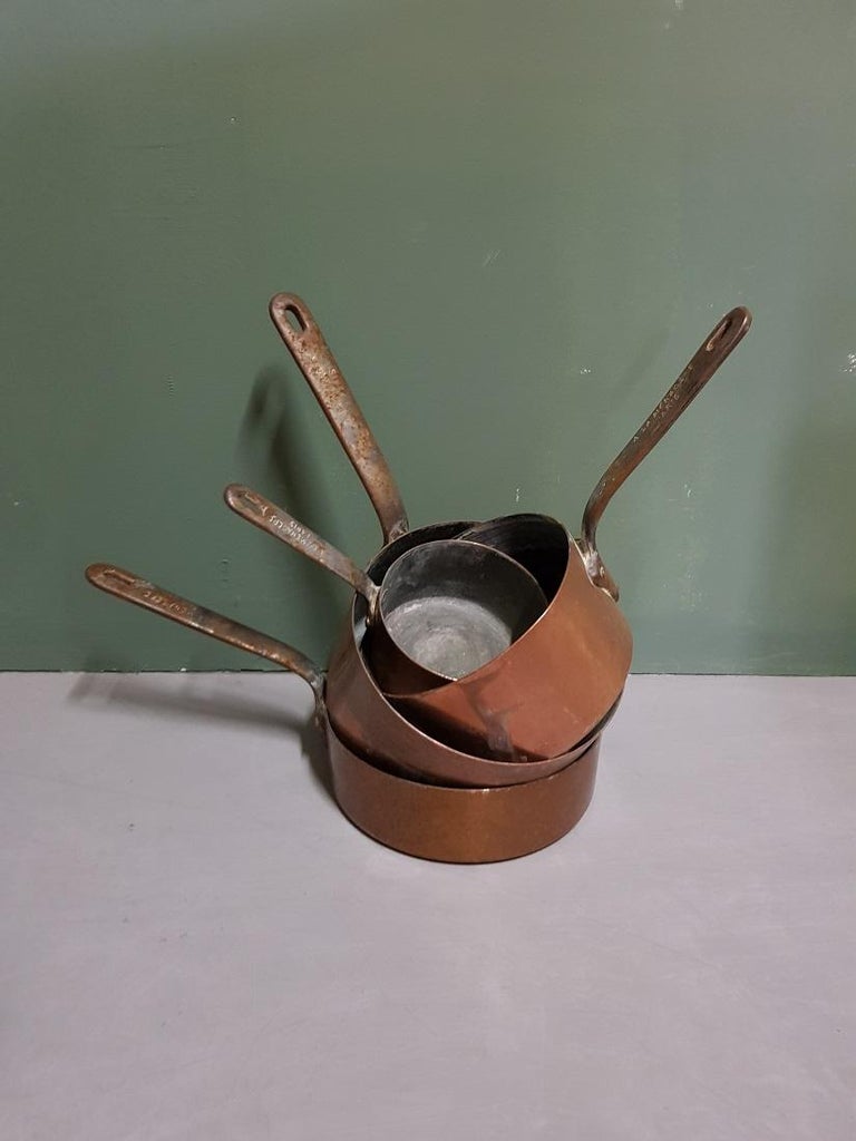 Old and heavy 4-piece French copper pan set marked 