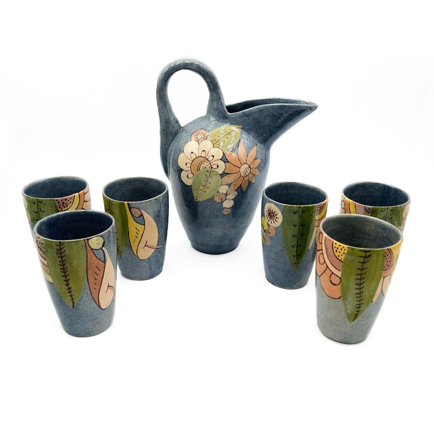 Beautifully glazed 1930's - 40's set of Mexican Tlaquepaque folk art pottery serving set. Includes a highly stylized shaped pitcher + 6 matching tumblers with a soft speckled blue glaze base and accented with a rich pastel decorative flora
