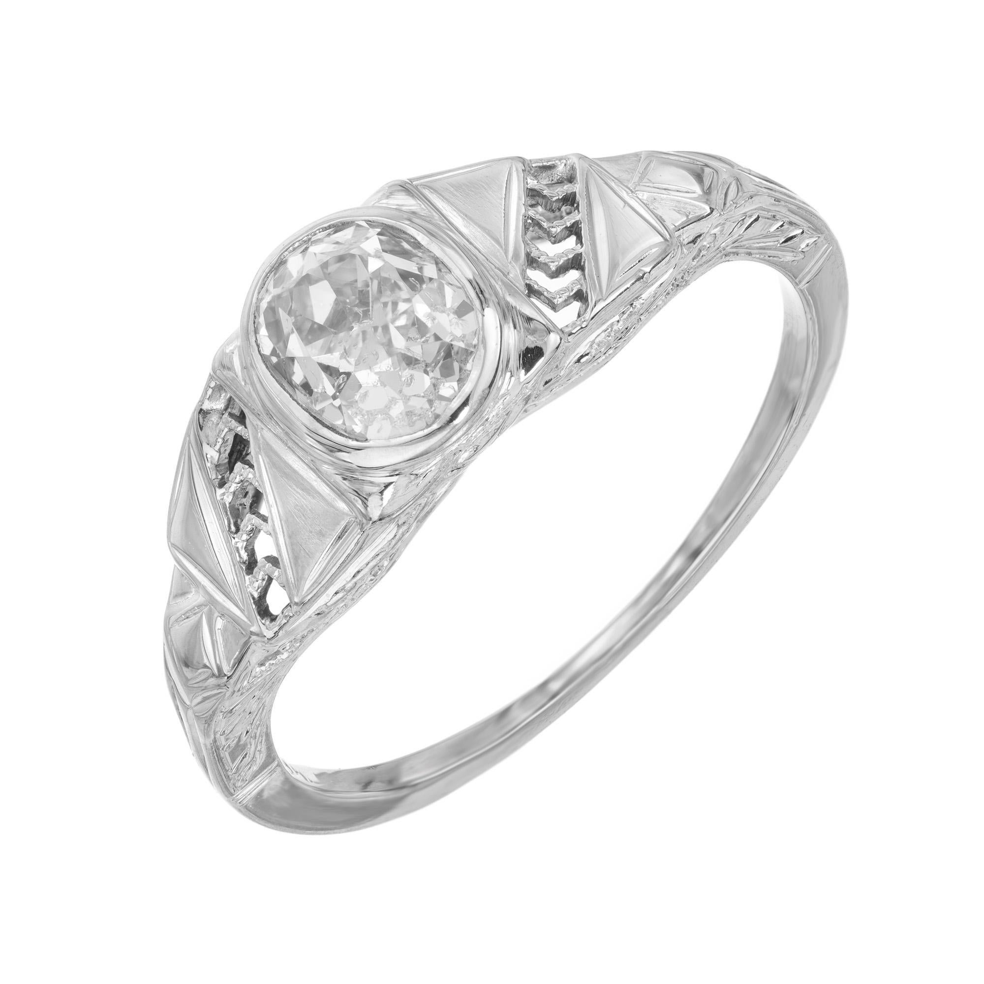Art Deco 1930s Old Mine brilliant cut diamond gold engagement ring. This exquisite piece is a harmonious blend of vintage charm and masterful craftsmanship, embodying the opulent style of the Art Deco period. The .82 carat bezel set diamond at its