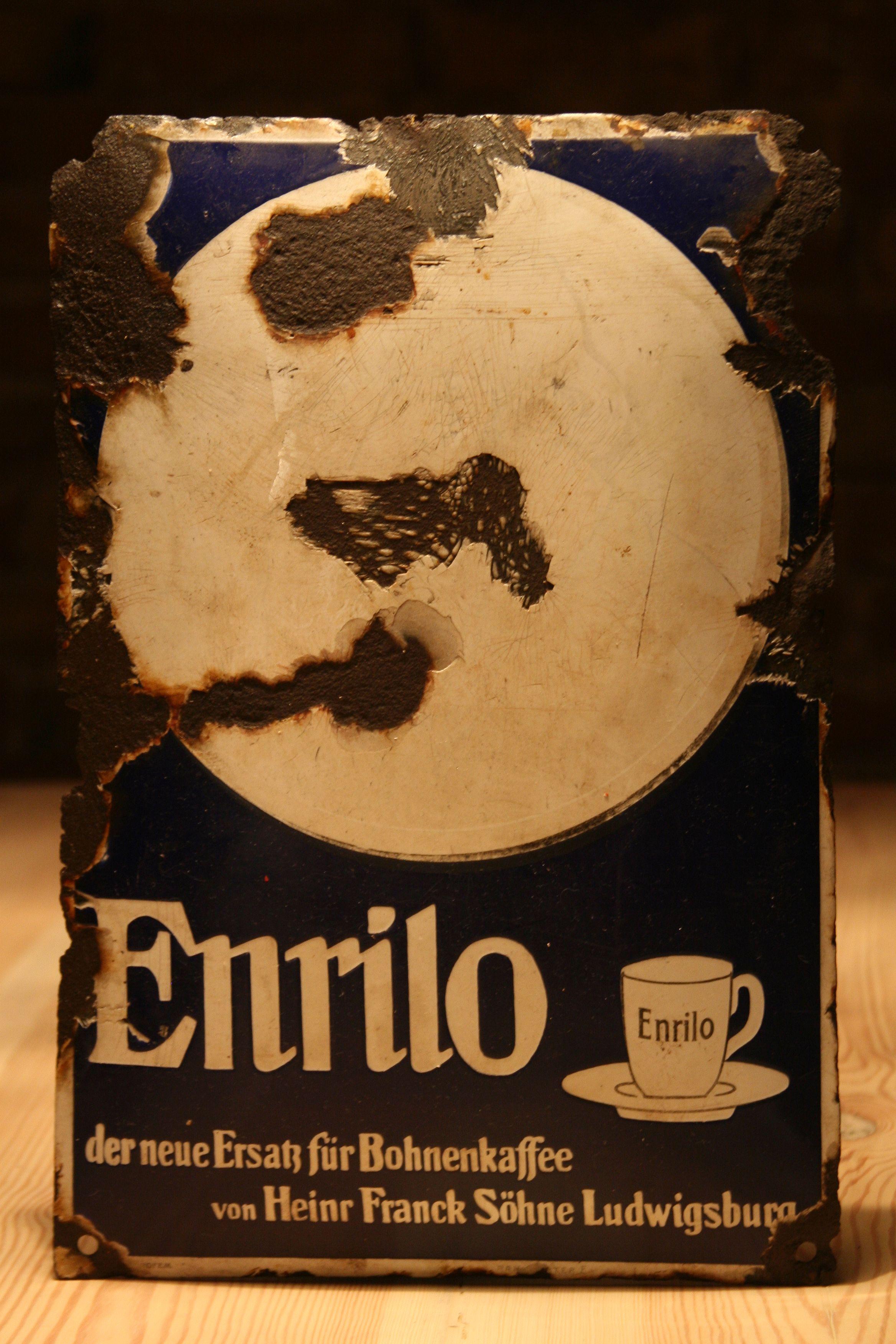 An original 1930s German advertising signboard, Enrilo coffee - a new alternative to the popular coffee beans.
Coffee producer: Heinr Franck Sohne Ludwigsburg, established in 1828.
Construction:
Pressed convex steel sheet covered with two-colored