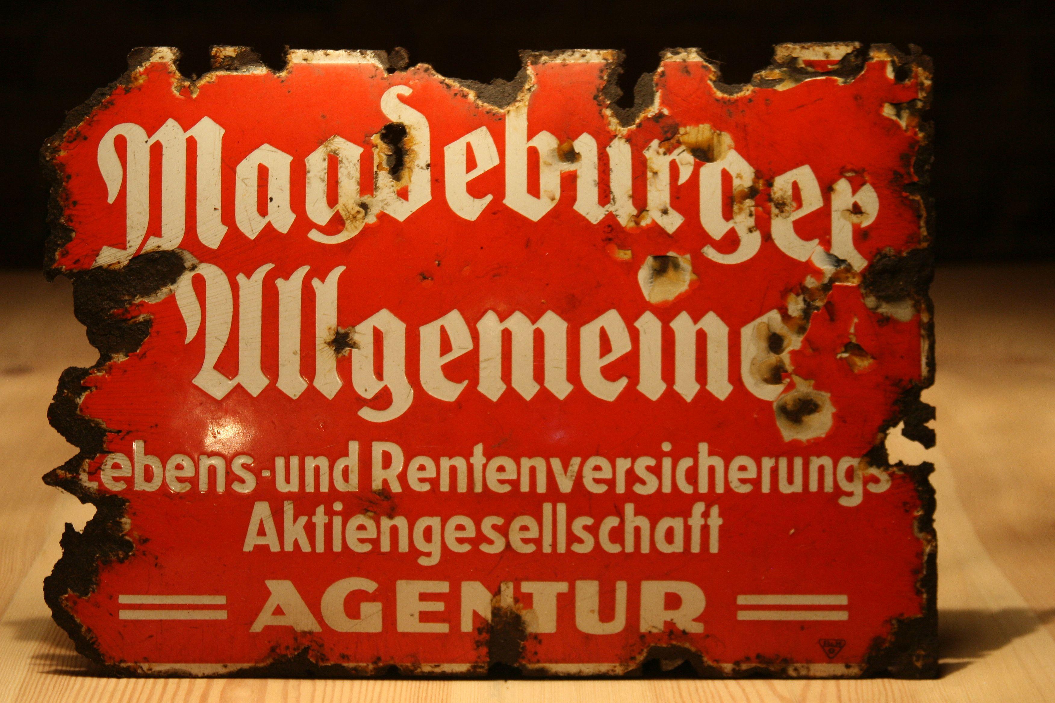 An original, 1930s German signboard of Magdeburg's joint stock company for life and retirement insurance.
Construction:
Pressed convex steel sheet covered with two-colored enamel. B & H, producer's signatures visible in the lower right
