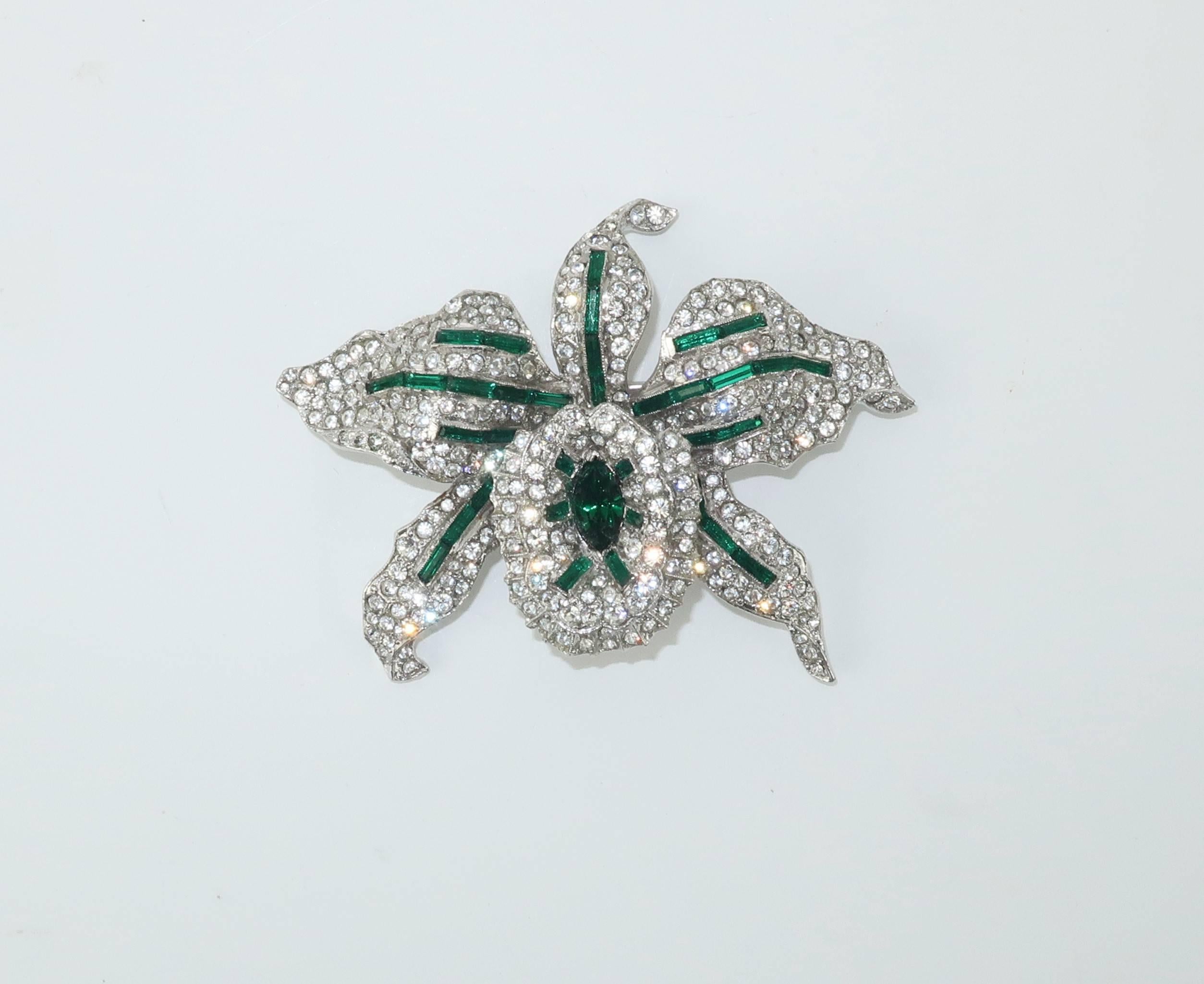 This gorgeous orchid brooch from Trifari with the 1930’s KTF hallmark will turn heads and garner admiration.  The design by Alfred Philippe has all the quality and beauty of fine jewelry with sparkling crystal rhinestones accented with emerald green