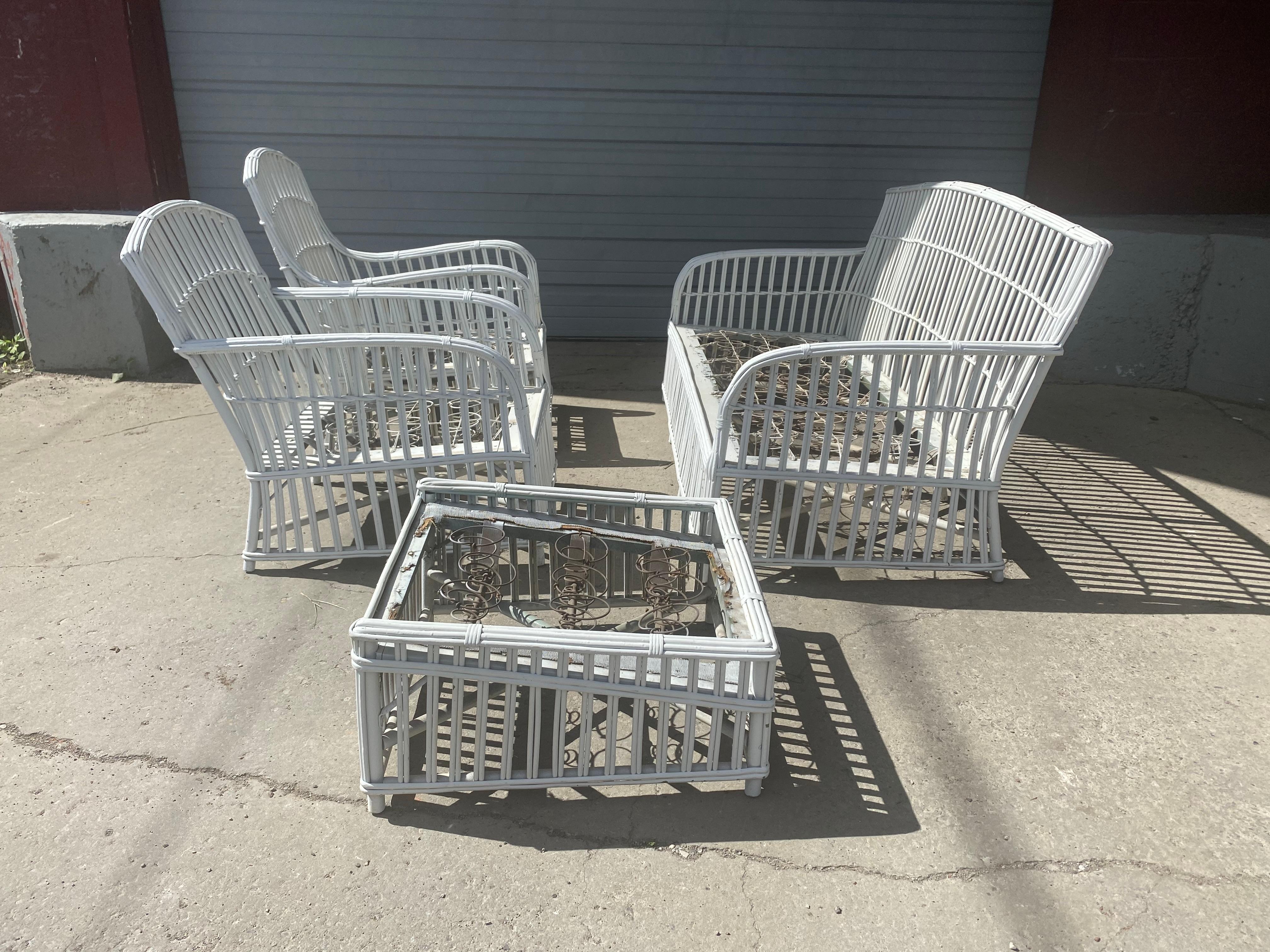 1930's American Art Deco 4 Piece Split Reed / Stick Wicker salon set, set consisting of settee. His and her's lounge chairs and matching ottoman, nice quality, painted white, spring construction platforms. Classic Deco/ Modernist styling, newer