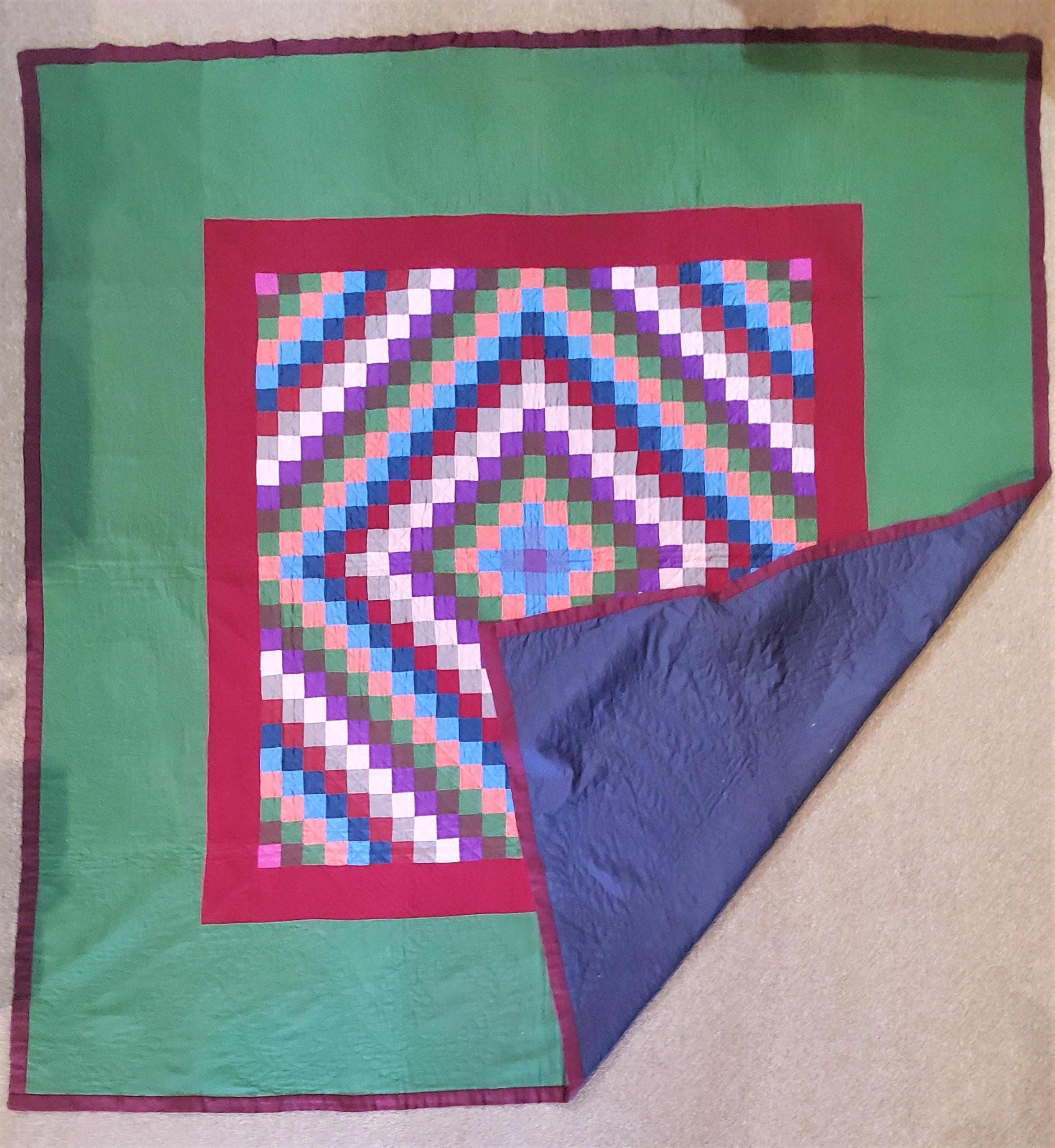 This 1930s Amish all wool Lancaster County, Pennsylvania sunshine and shadow in a square. This contained sunshine and shadow quilt is in pristine condition. The backing is a blue cotton sateen fabric. This quilt is finely quilted and great piecework.