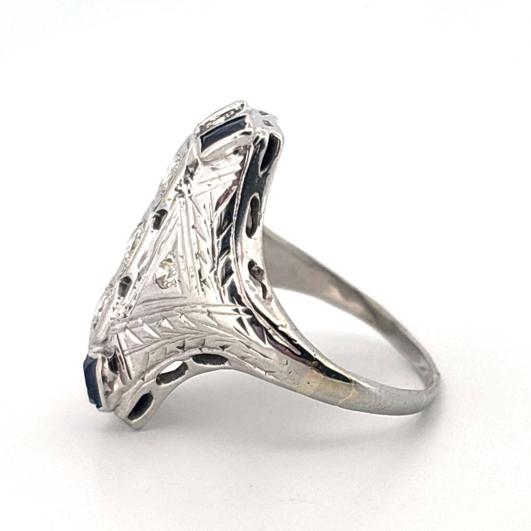 
This exquisite 1930’s Art Deco ring is a true antique treasure, masterfully crafted in 18K white gold and showcasing the bold geometry of the era. The elongated navette-style setting features four sparkling old European cut diamonds, totaling