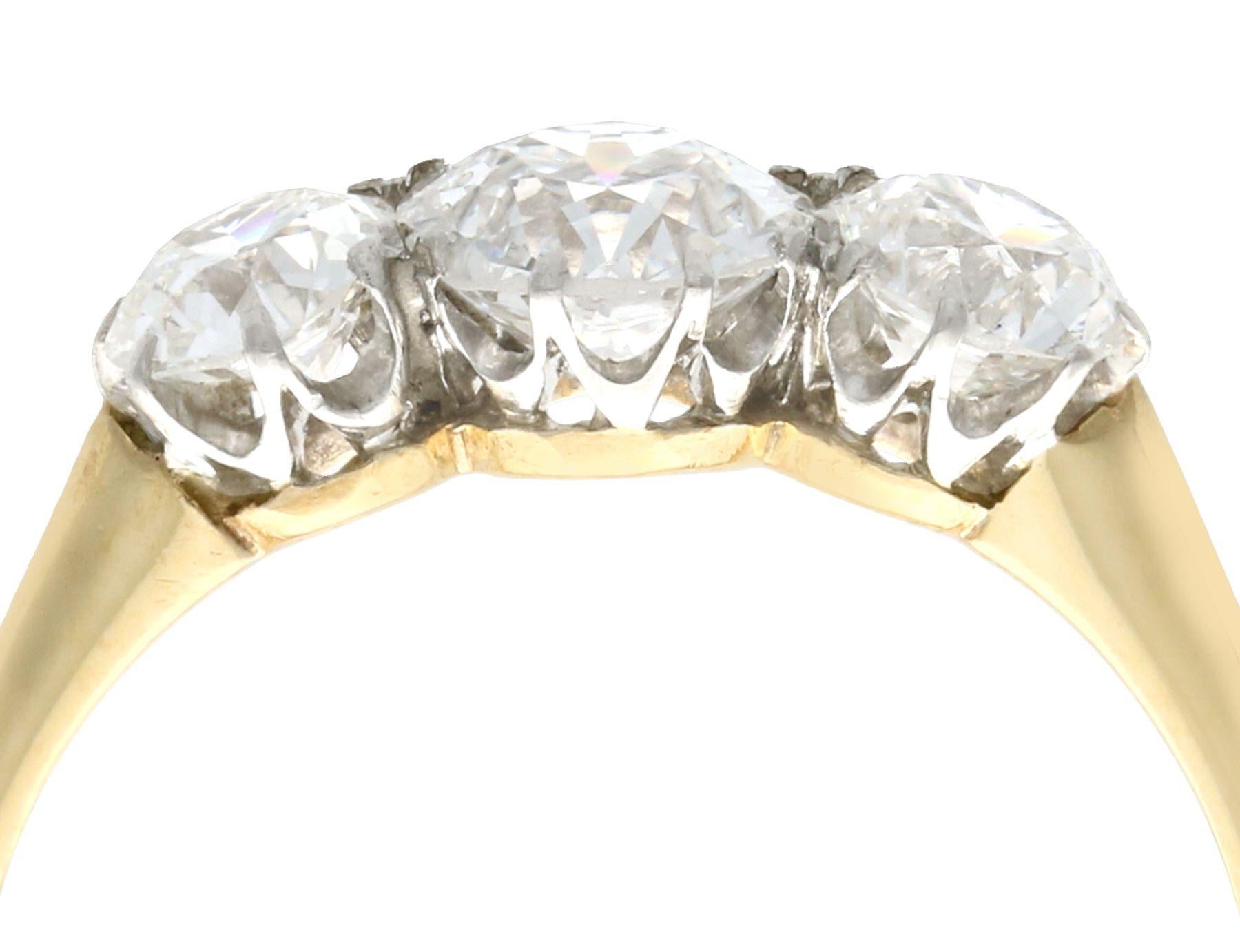 A stunning, fine and impressive antique 1.56 carat diamond, 18 karat yellow gold and platinum trilogy ring; part of our diverse antique jewellery and estate jewelry collections.

This stunning, fine and impressive antique trilogy ring has been