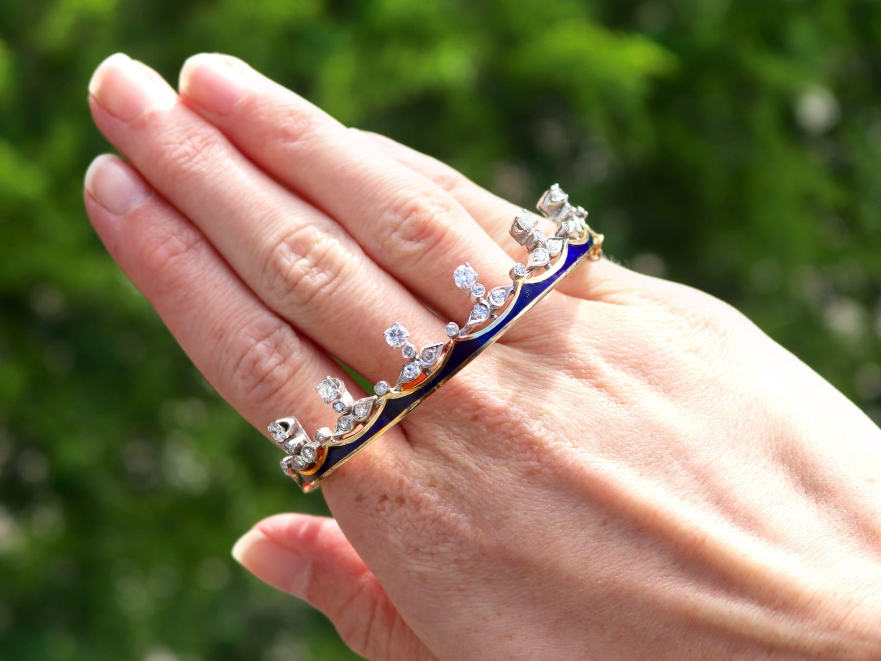 A stunning, fine and impressive 1.62 carat diamond and blue enamel, 14 karat yellow gold and 14 carat white gold set bangle, modelled in the form of a 'crown'; part of our diverse antique jewelry and estate jewelry collections.

This stunning, fine
