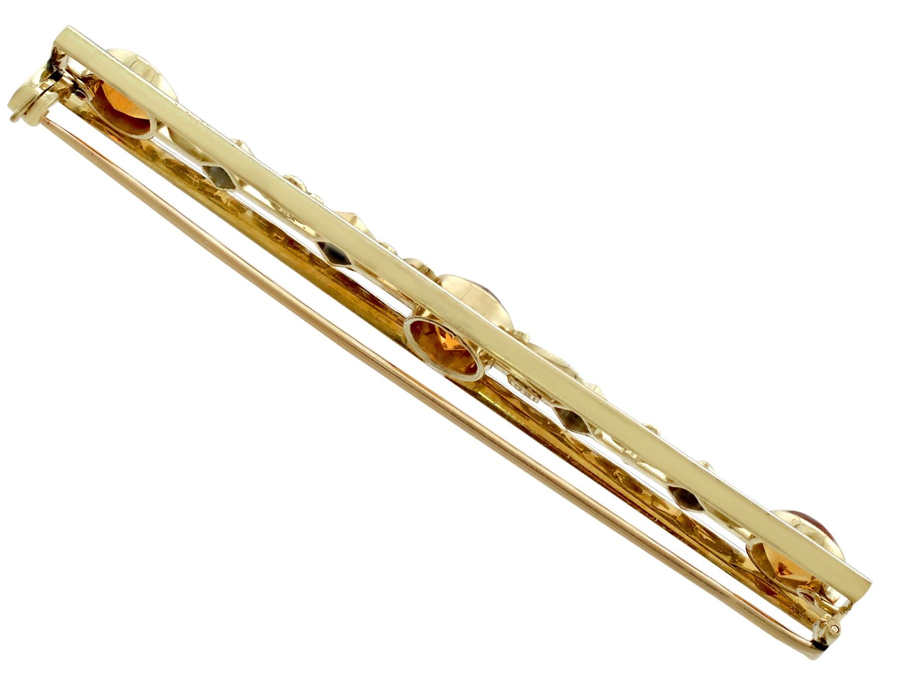An impressive antique 3.10 carat citrine and 0.75 carat sapphire, enamel and 15 karat yellow and white gold bar brooch; part of our diverse antique jewellery collections.

This fine and impressive antique gemstone brooch has been crafted in 15k