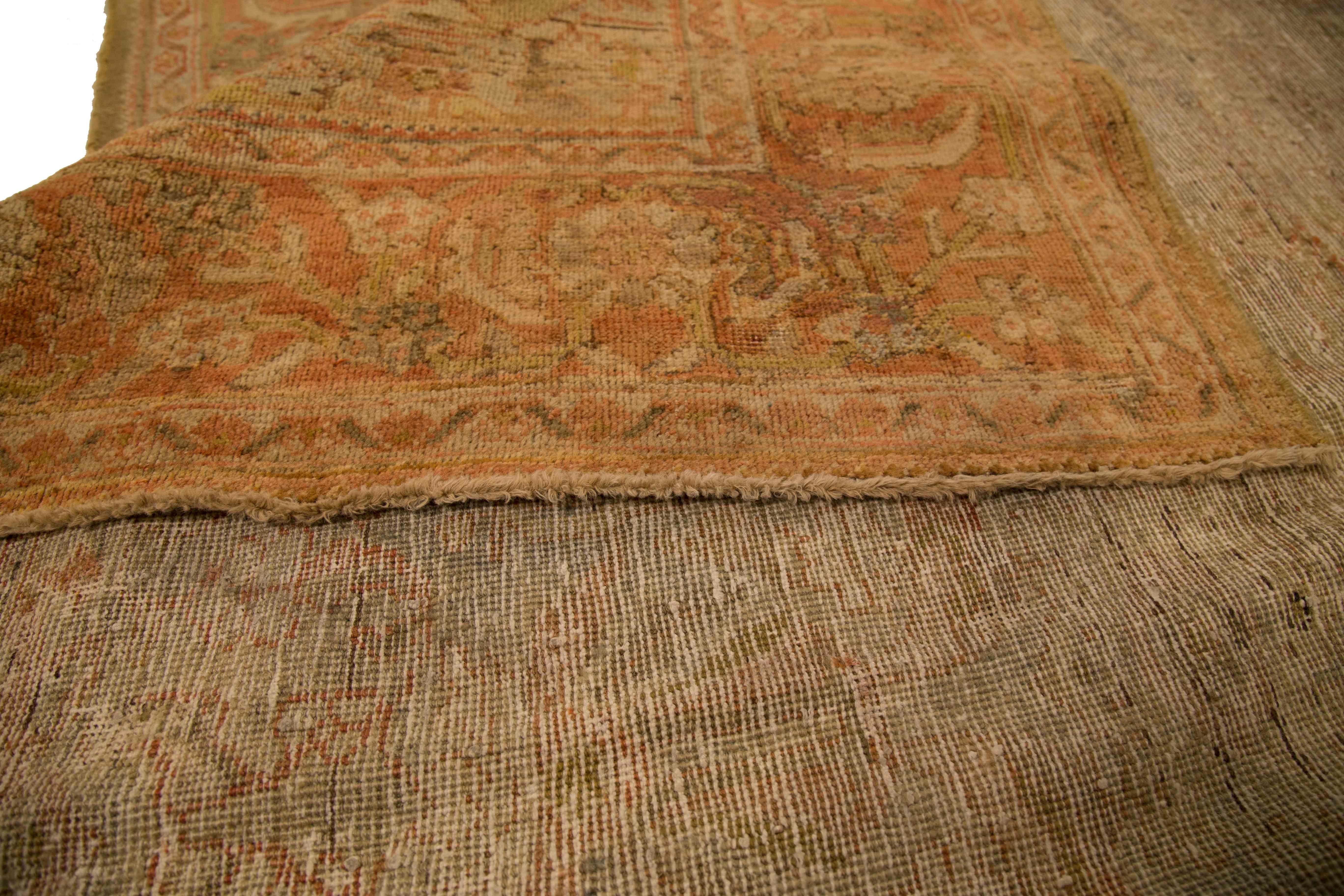 Antique Persian rug made of fine wool and organic dyes. It’s handwoven using design patterns popularized by weavers in Malayer, one of the biggest rug making centers in ancient Persia. It features an intricate weave of floral details using warm,