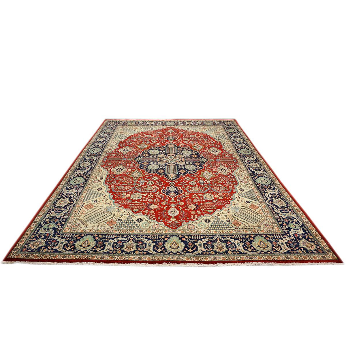 Ashly Fine Rugs presents a 1930s antique Persian Tabriz. Tabriz is a northern city in modern-day Iran and has forever been famous for the fineness and craftsmanship of its handmade rugs. This piece has a light ivory-colored background with a large