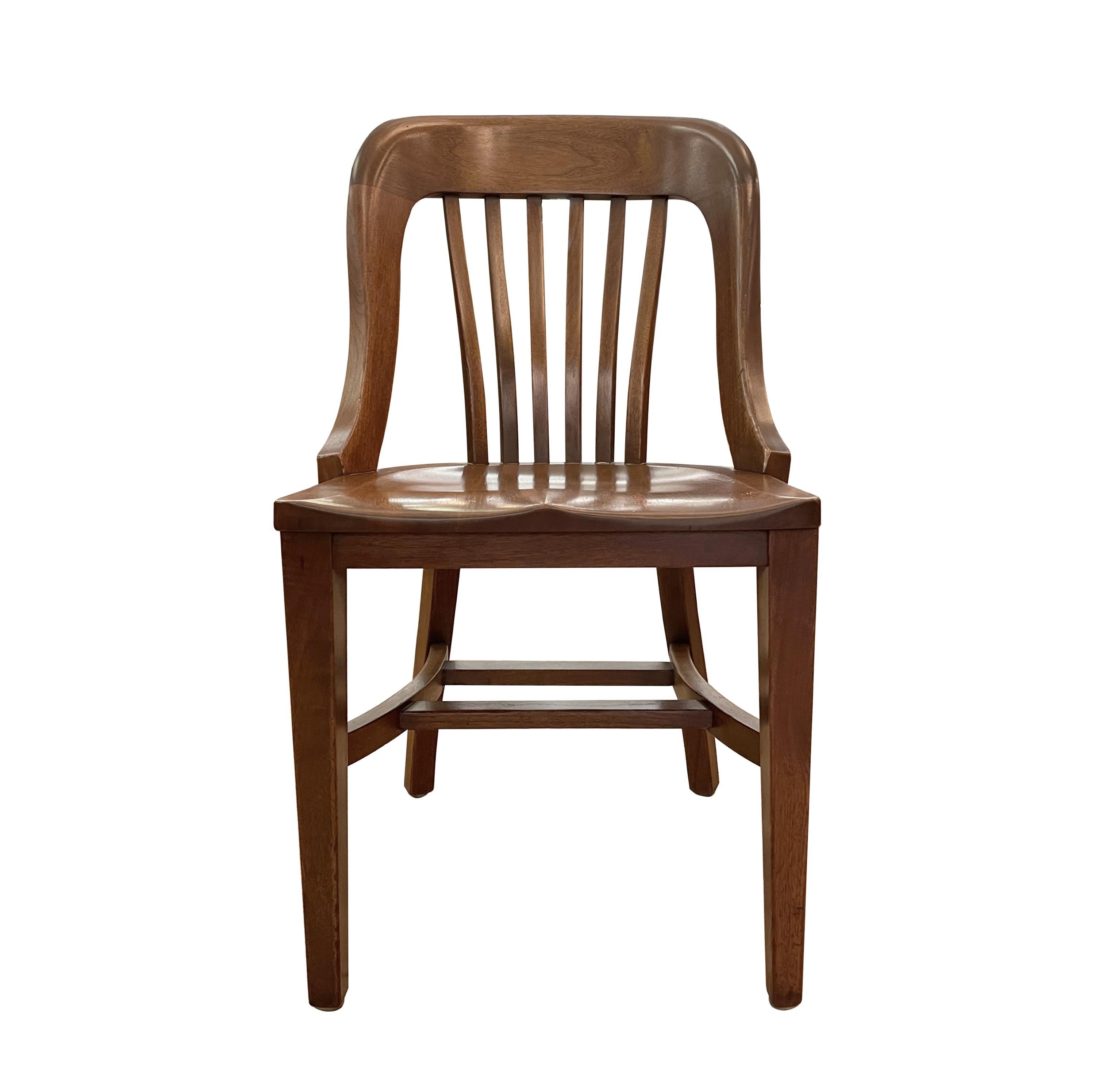 This 1930s armless solid walnut library chair exemplifies Early 1930s American craftsmanship. Made in Ohio. With it's elegant design, sturdy walnut construction, and timeless appeal, it adds a level of sophistication and comfort to any library or