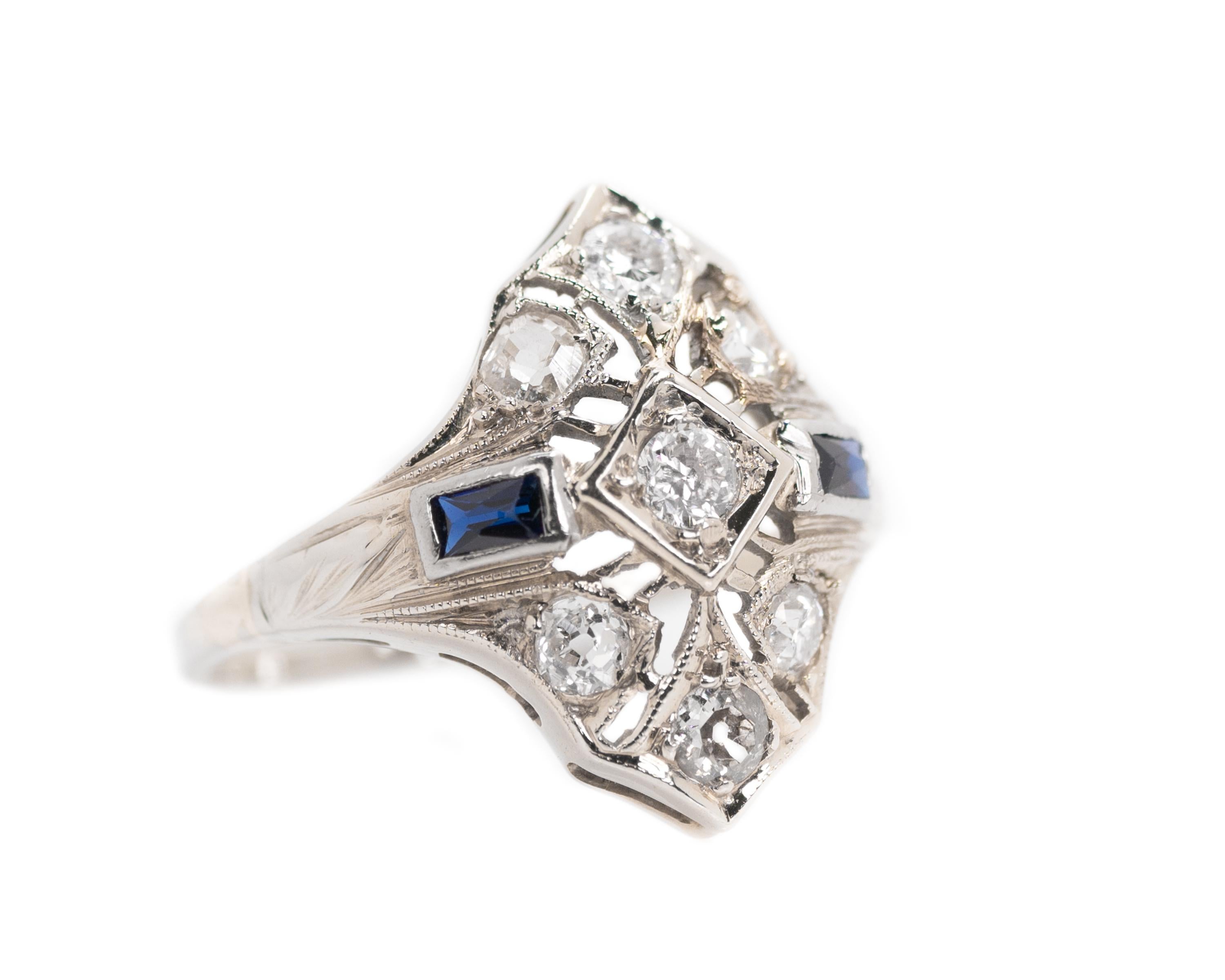 1920s Art Deco Engagement Ring - Platinum, Old Mine Diamonds, Blue Sapphires

Features: 
0.25 carat total weight round Old Mine Diamonds
2 French cut Blue Sapphires
Platinum setting with filigree work and an open Gallery 

Ring face measures 17