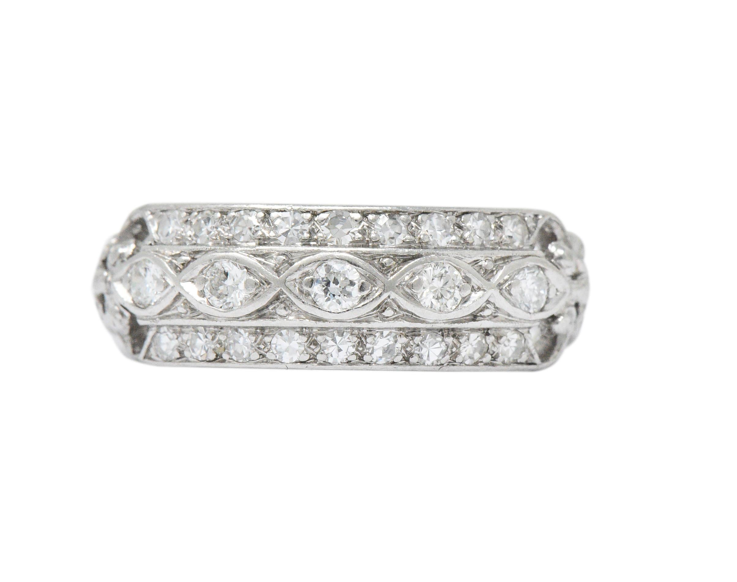 Set to the front with five full cut diamonds weighing approximately 0.15 carat total

Accented with eighteen single cut diamonds weighing approximately 0.30 carat total

Diamonds are F/G color and VS clarity

Lovely scrolling and weaving