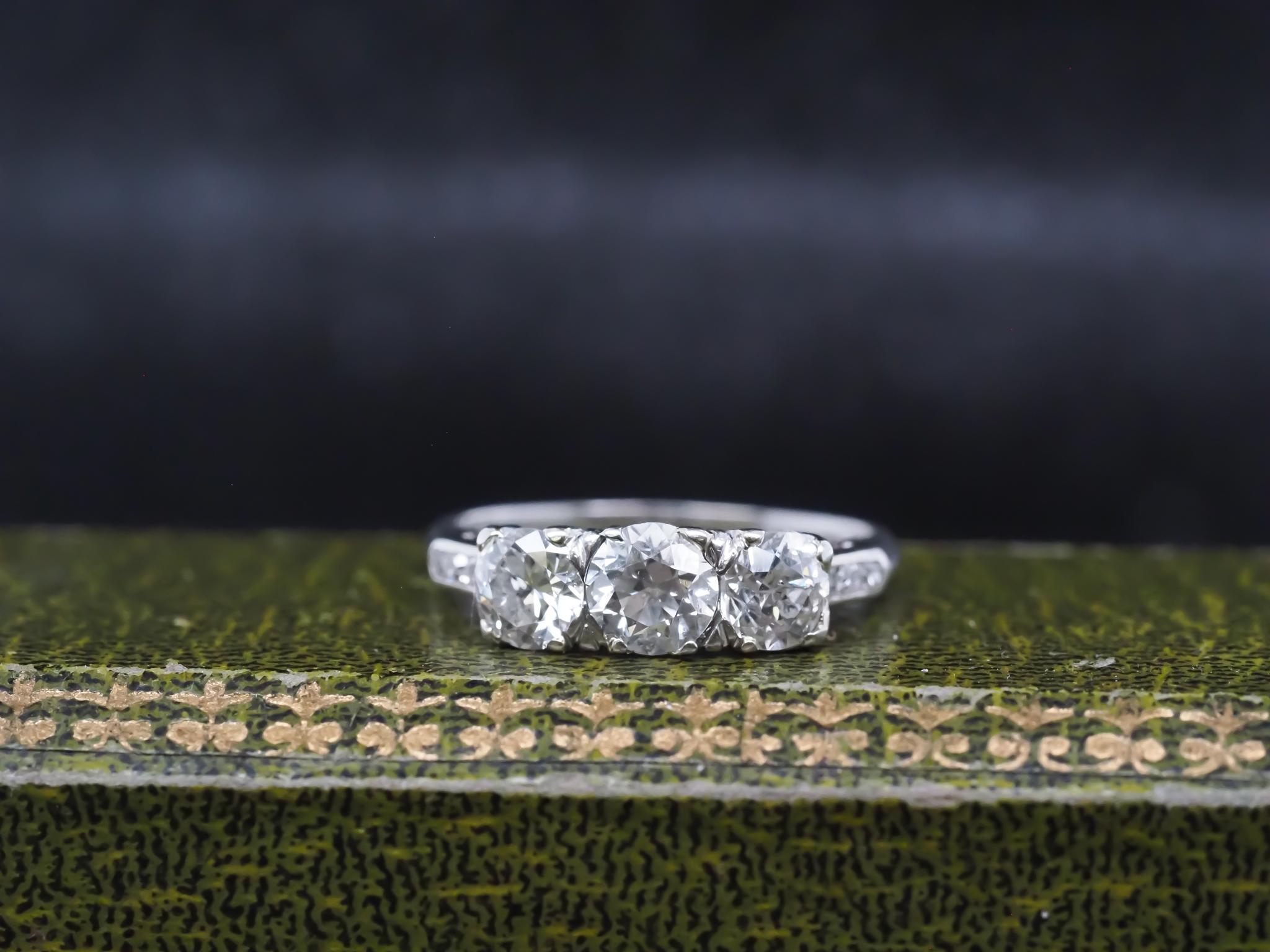 Year: 1930s

Item Details:
Ring Size: 6.5 (Sizable)
Metal Type: 14K White Gold [Hallmarked, and Tested]
Weight: 2.3 grams

Diamond Details: 1.50ct total weight. (Center diamond is .60ct, sides are .90 total ) - I/J Color, VS/SI Clarity, Natural