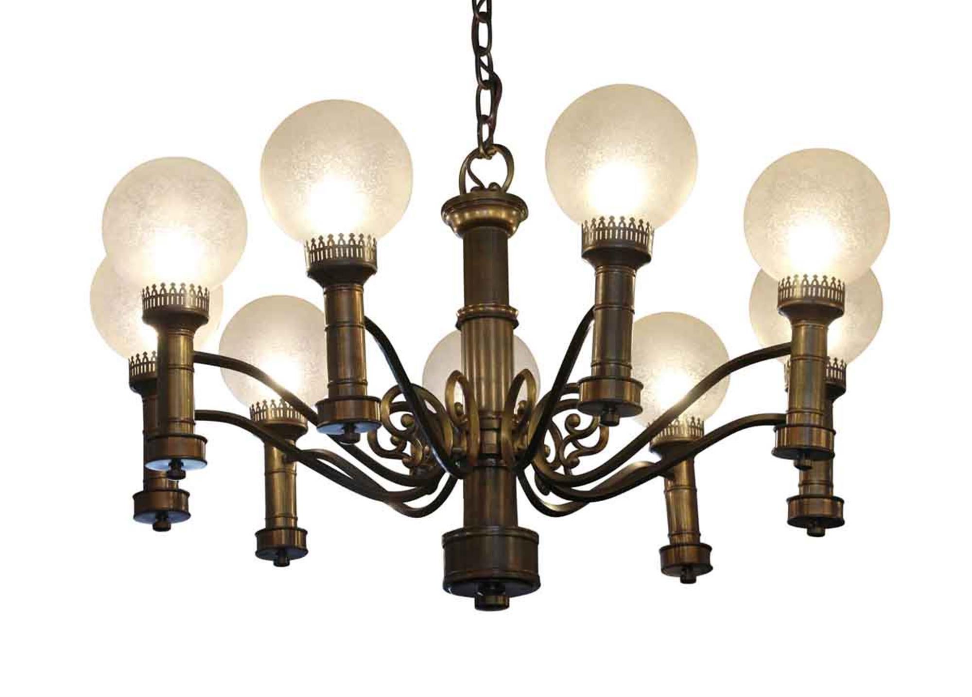 1930s brass nine arm Art Deco chandelier with round textured globes. Salvaged from a building in Illinois. This can be seen at our 2420 Broadway location on the upper west side in Manhattan.