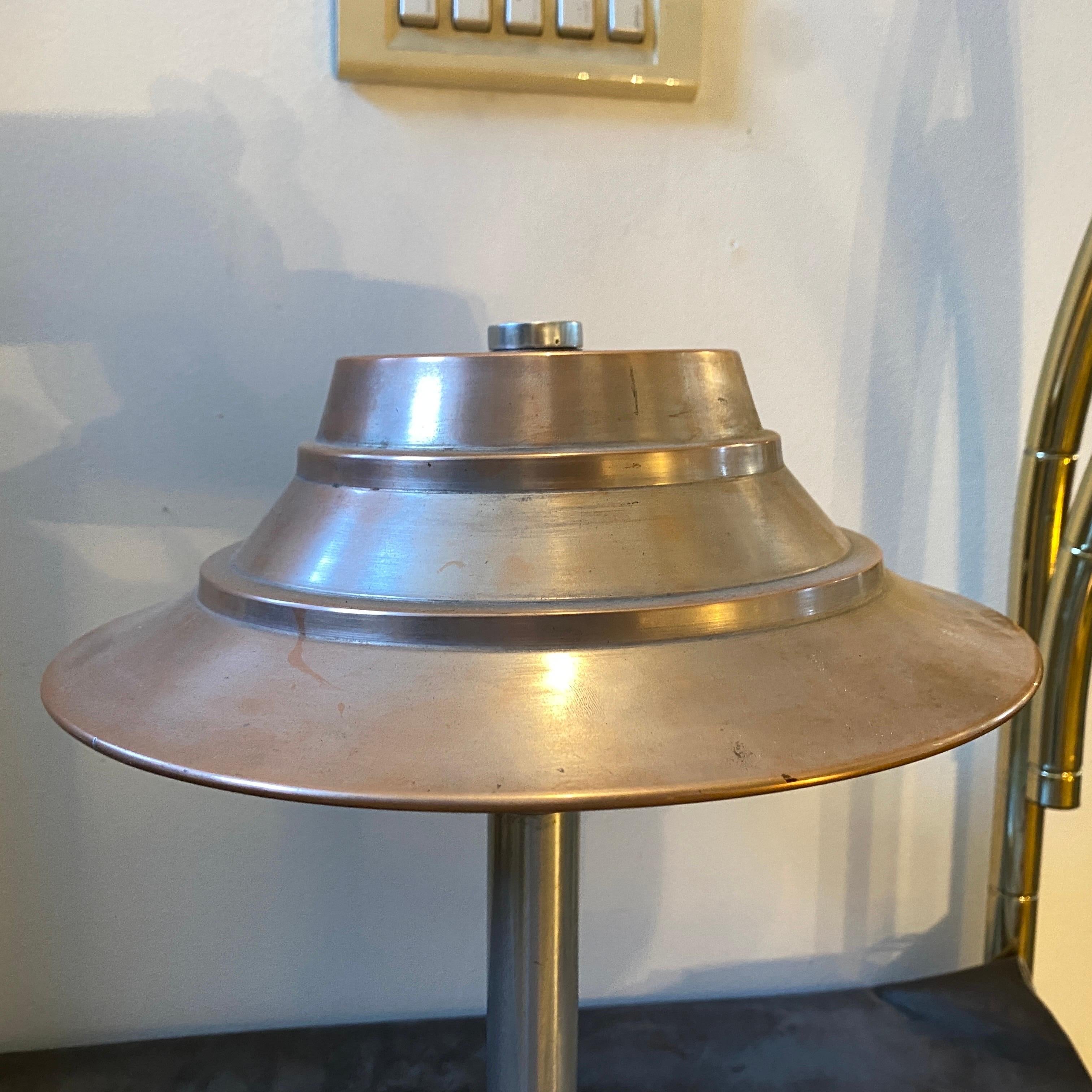 A stylish Art Deco table lamp designed and manufactured in Milano by Mario Corio & c. The pink aluminum top it's in perfect condition as the natural aluminum stem. It works both 110 and 240 volts and it needs a regular bulb. It's in perfect working