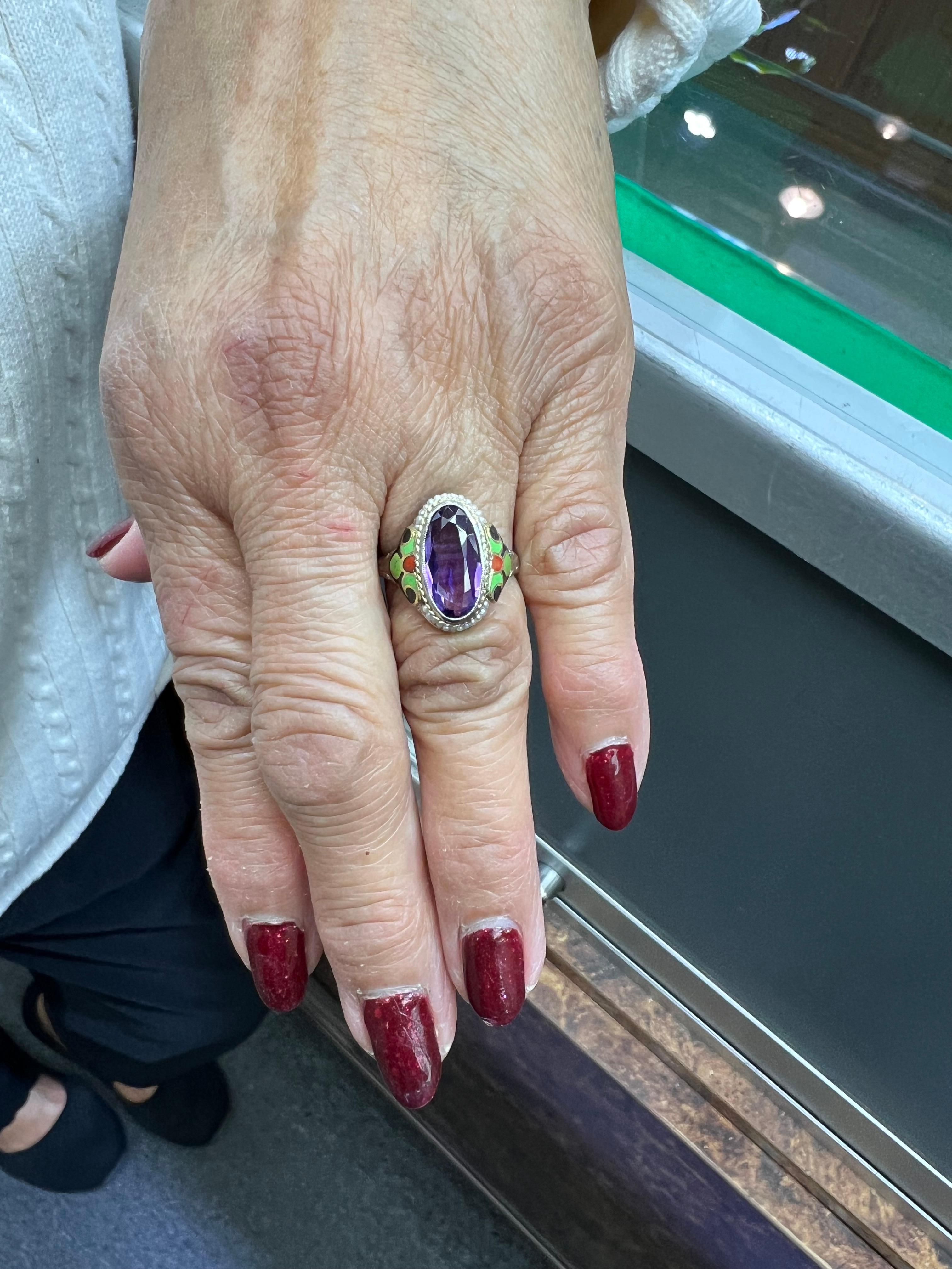 1930s Art Deco Amethyst enamel and seed pearl 14k white gold ring.

The 1930s Art Deco amethyst, enamel, and seed pearl ring crafted from 14K white gold exemplifies the distinctive characteristics of the Art Deco movement. This era, spanning from