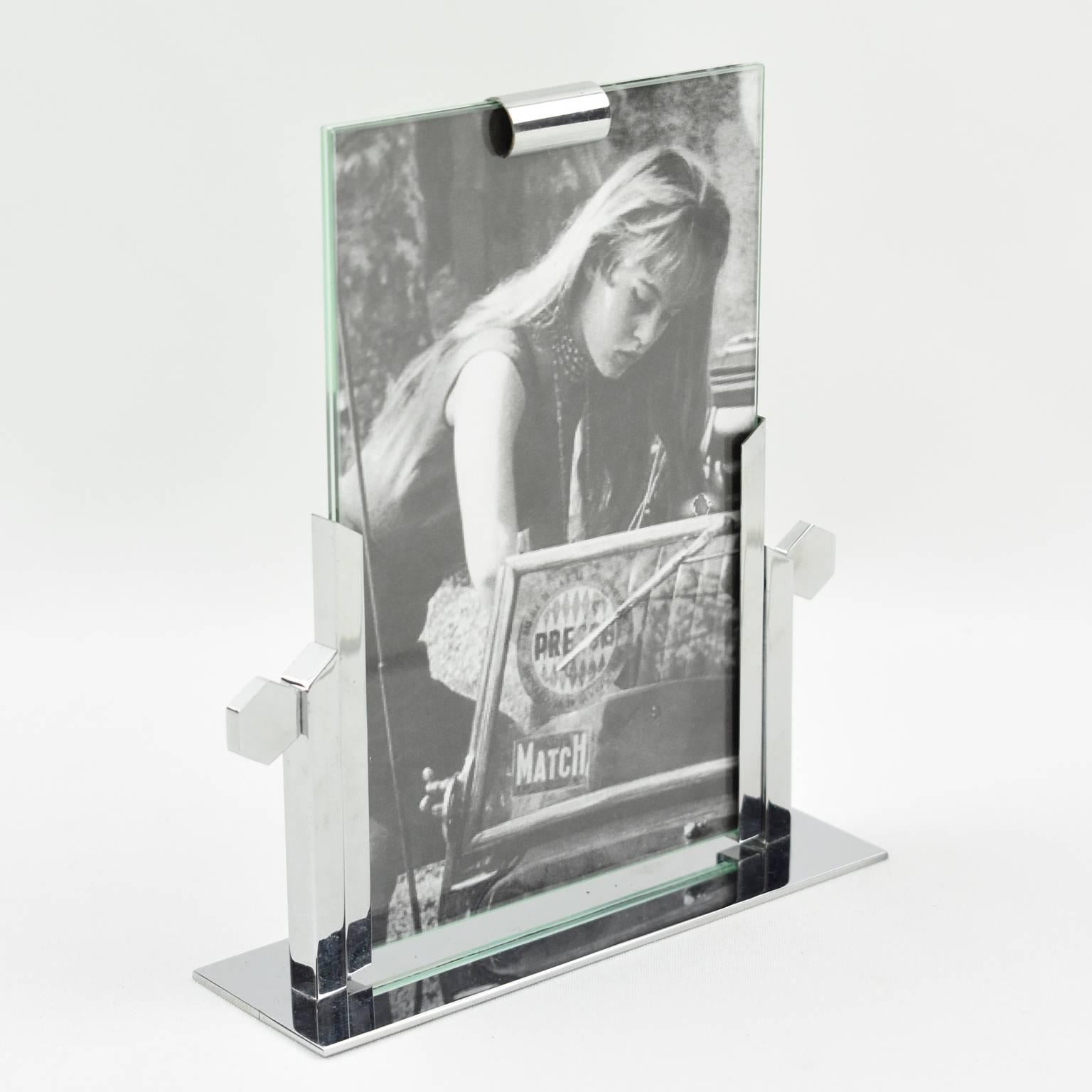 French Art Deco picture photo frame. Architectural all chrome shape with flat rectangular base and two vertical frame supports with side detailing. The two supports hold two glass sheets which can hold a photo or image. 
Measurements:
Overall: 5.13