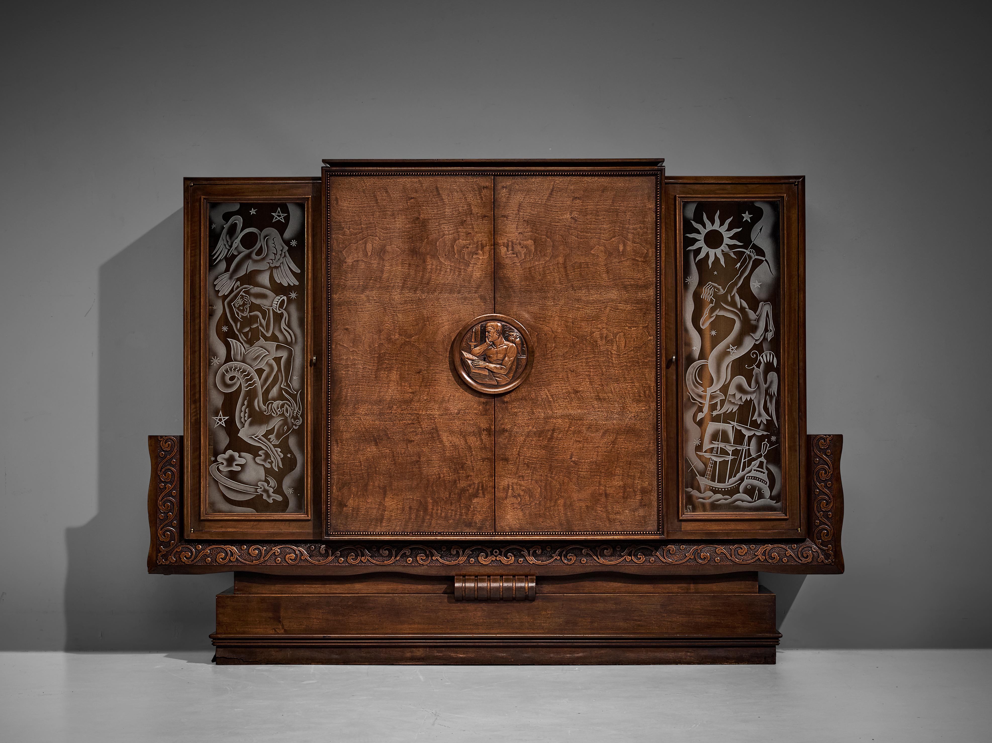 Armoire, walnut, glass, France, 1930s 

This exceptional armoire undoubtedly breathes the Art Deco Period of the 1930s. The design convinces visually through its grotesque execution of ornamental arrangements on the glass panels featuring
