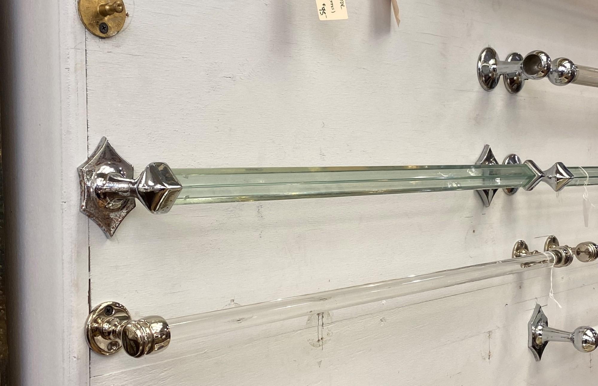 1930s square glass bath room towel bar paired with hexagon shaped chrome over brass ends. This can be seen at our 333 West 52nd St location in the Theater District West of Manhattan.