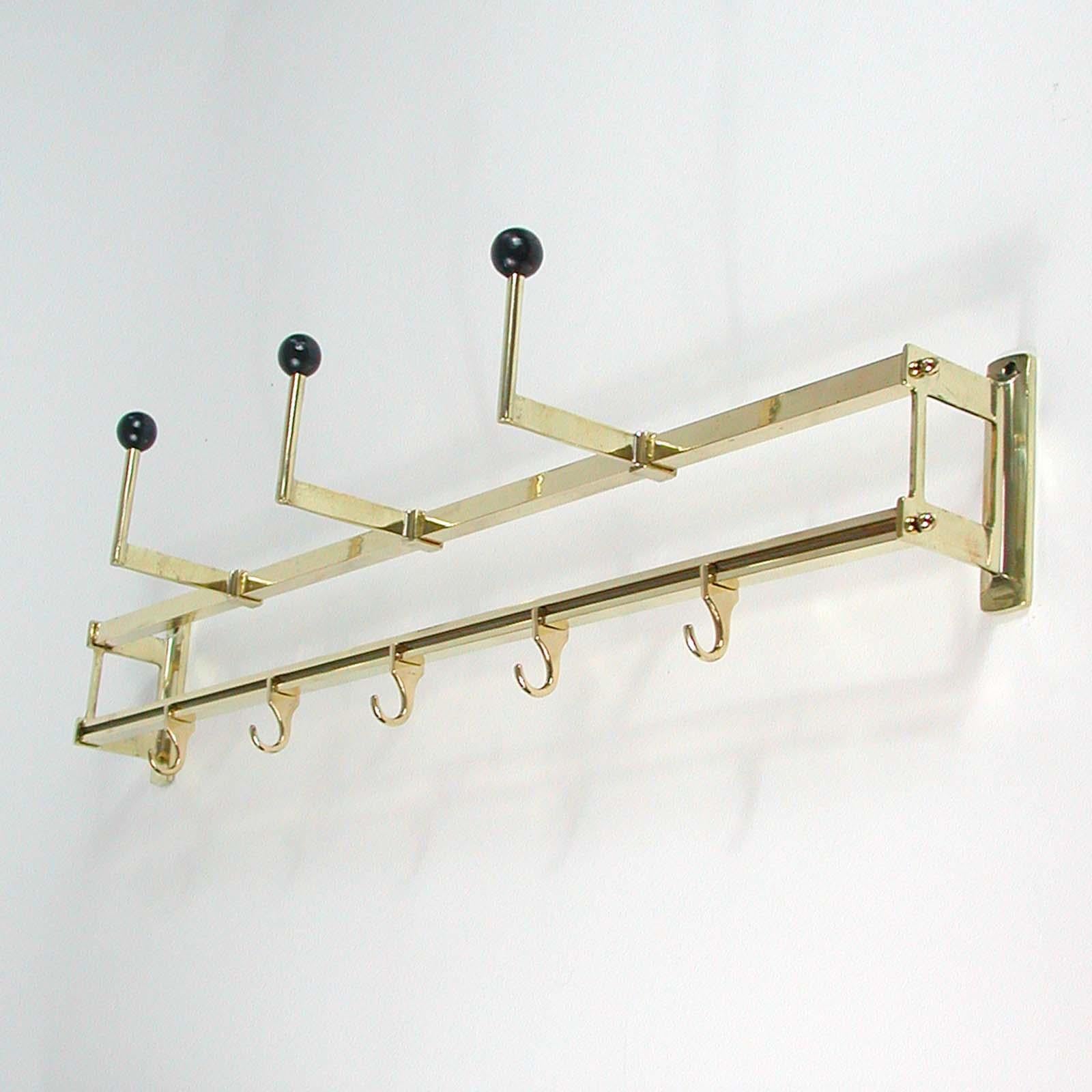 This vintage coat and hat rack was made in Germany in the 1930s during the Art Deco / Bauhaus period. It is made of brass, has got five movable hooks in the lower part and three black lacquered wooden hooks in the upper part.

Condition is good