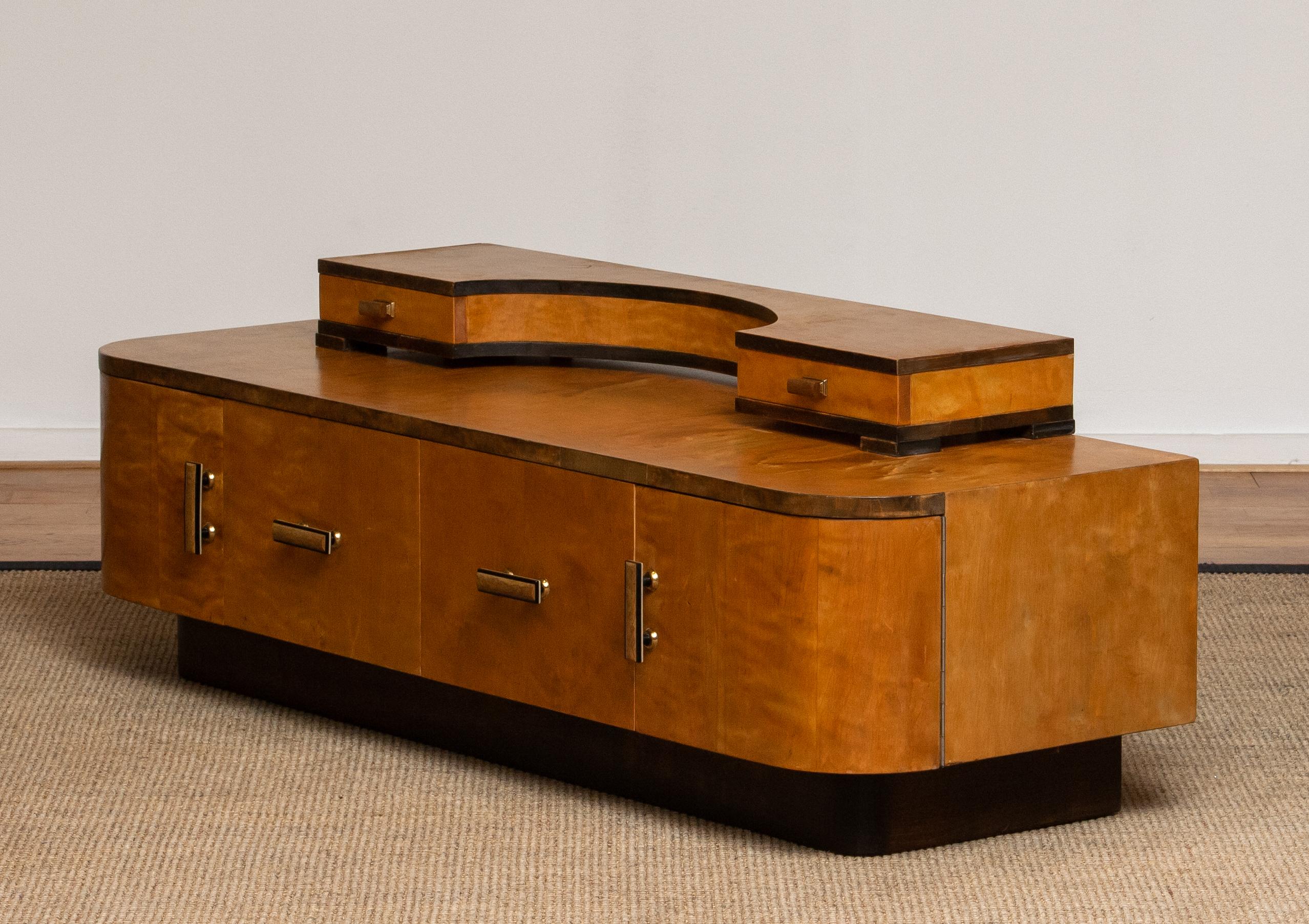 Exceptionally rare and beautiful Art Deco vanity or low board in birch from Norway and attributed to Eliel Saarinen, 1930s.
This vanity has two drawers as well as two drawers with rotary mechanism. On top there are two small drawers as well.
It's