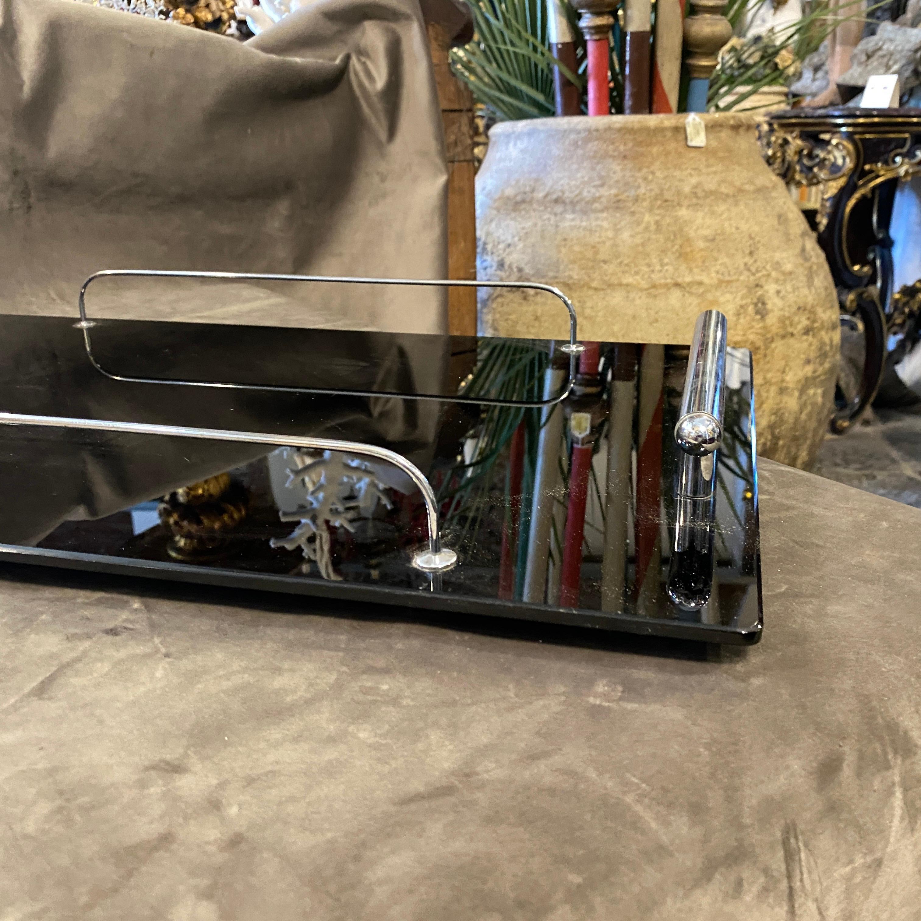 An high quality Art Deco serving tray designed and manufactured in Italy in the Thirties, black glass and chromed metal are in perfect conditions. It's a fine example of italian art deco. 