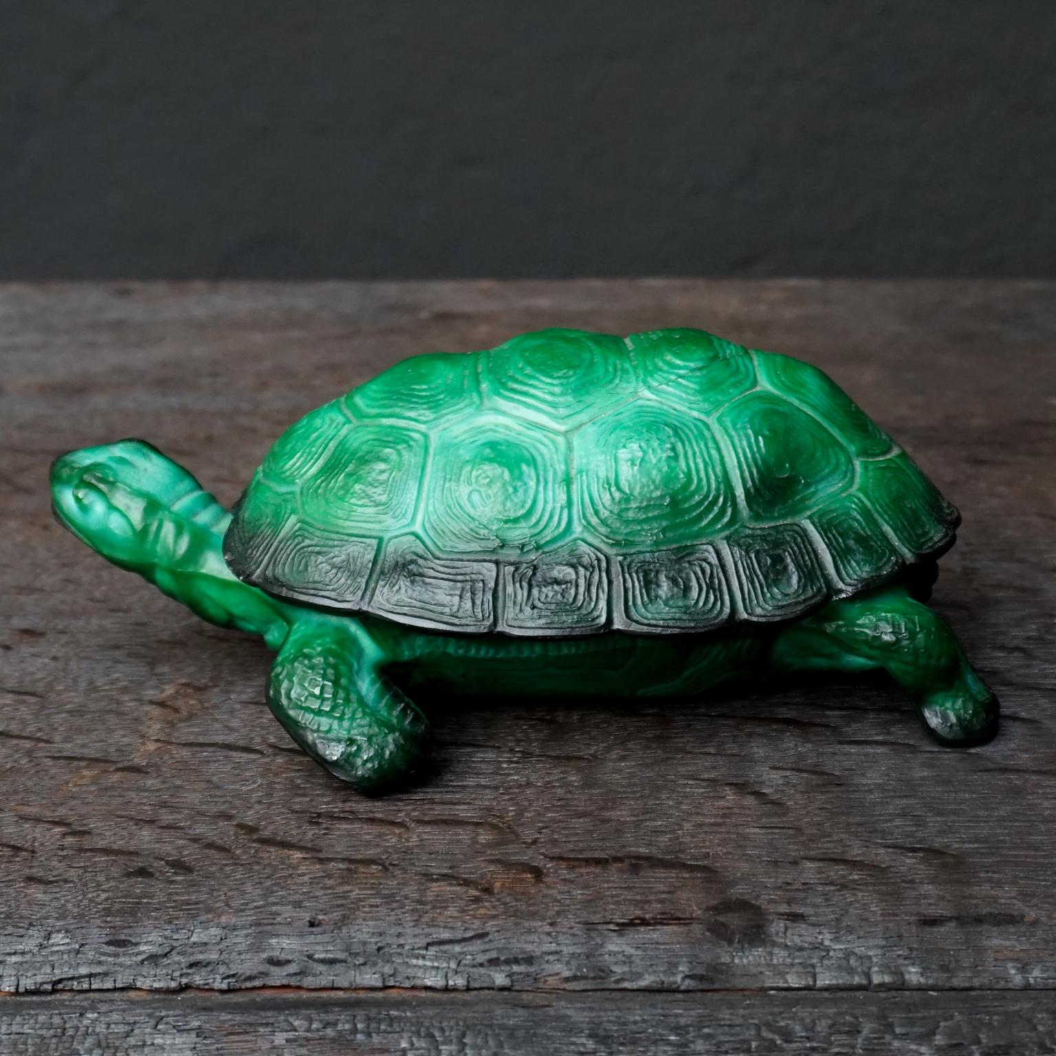 A lovely 1930s Art Deco Czech Republic made malachite glass turtle trinket dish, by Curt Schlevogt designed by Mario Petrucci

Malachite glass is intended to look like malachite (a green copper carbonate mineral), or more generally, to look like