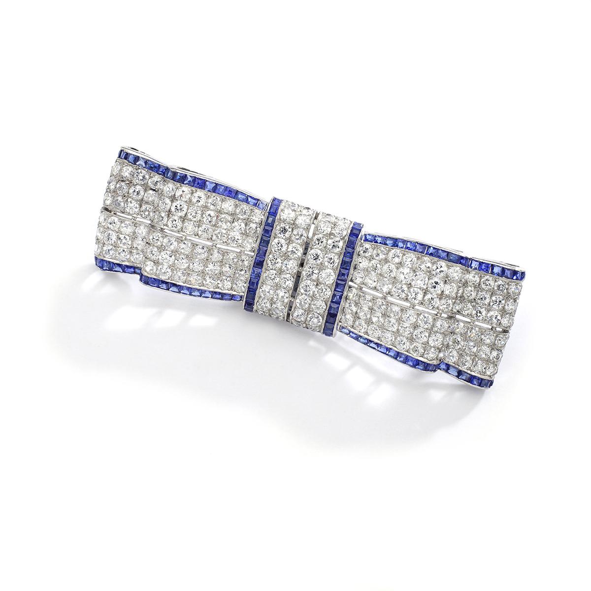 Former property of an English Gentleman.
Elegant and Stunning as usual Art Deco design is one of our favorite period.
Bow tie brooch in diamond and calibrated sapphires. Circa 1930.
French mark for platinum.

Measures:
Length: 6.5 centimeters (2.6