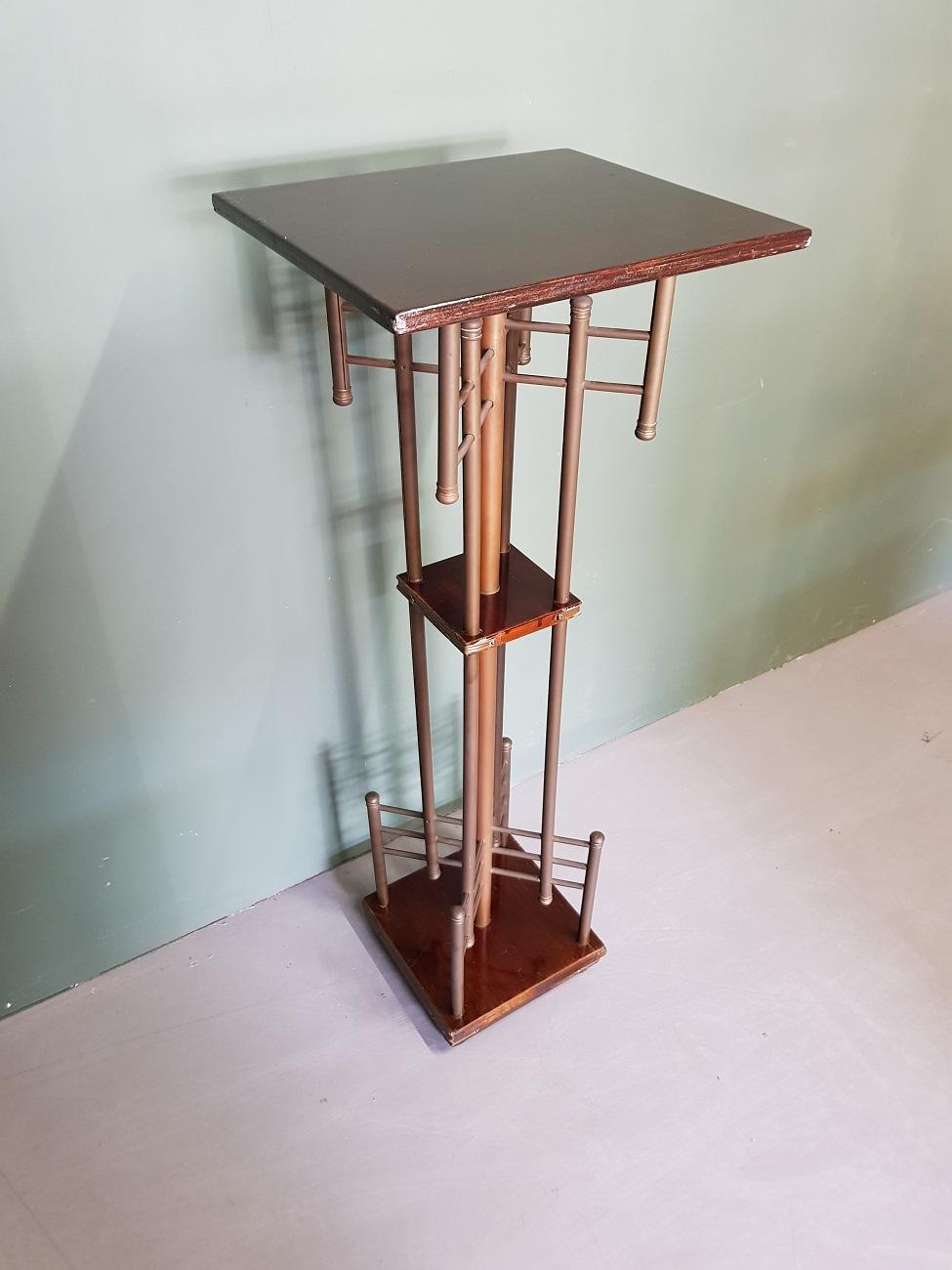 Art Deco plant table or pedestal made of brass tubes and wooden between trays, made in the 1930s.

The measurements are:
Depth 32 cm/ 12.5 inch.
width 36 cm/ 14.1 inch.
Height 99 cm/ 38.9 inch.