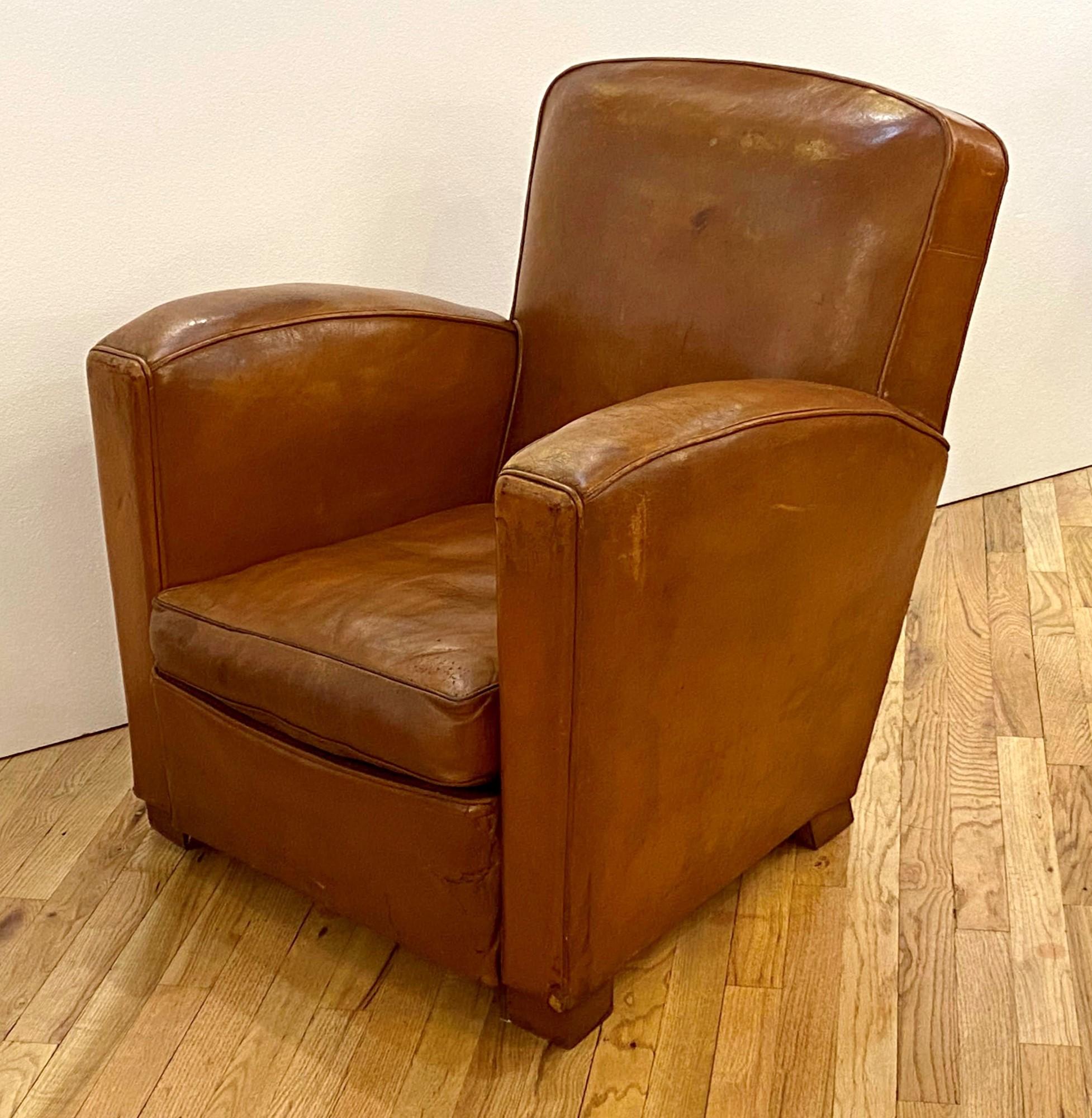 Refurbished Art Deco brown leather French single club chair from the 1930s. There is minor wear. One available. This can be seen at our 333 West 52nd St location in the Theater District West of Manhattan.