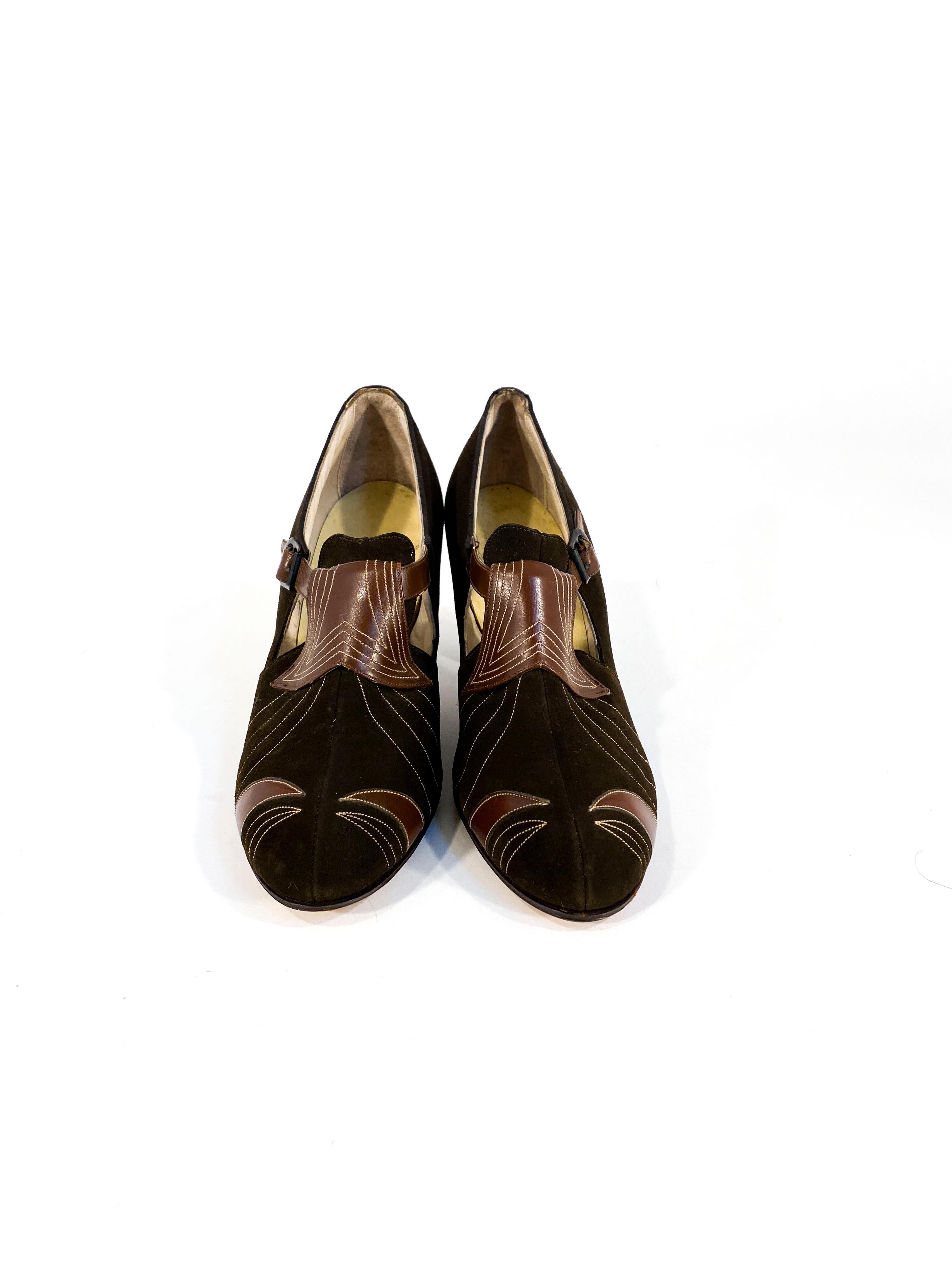 1930s brown suede and leather heels with Art Deco top stitching, cut outs, and metal buckle. The heel measures 2.5 inches from the ground.