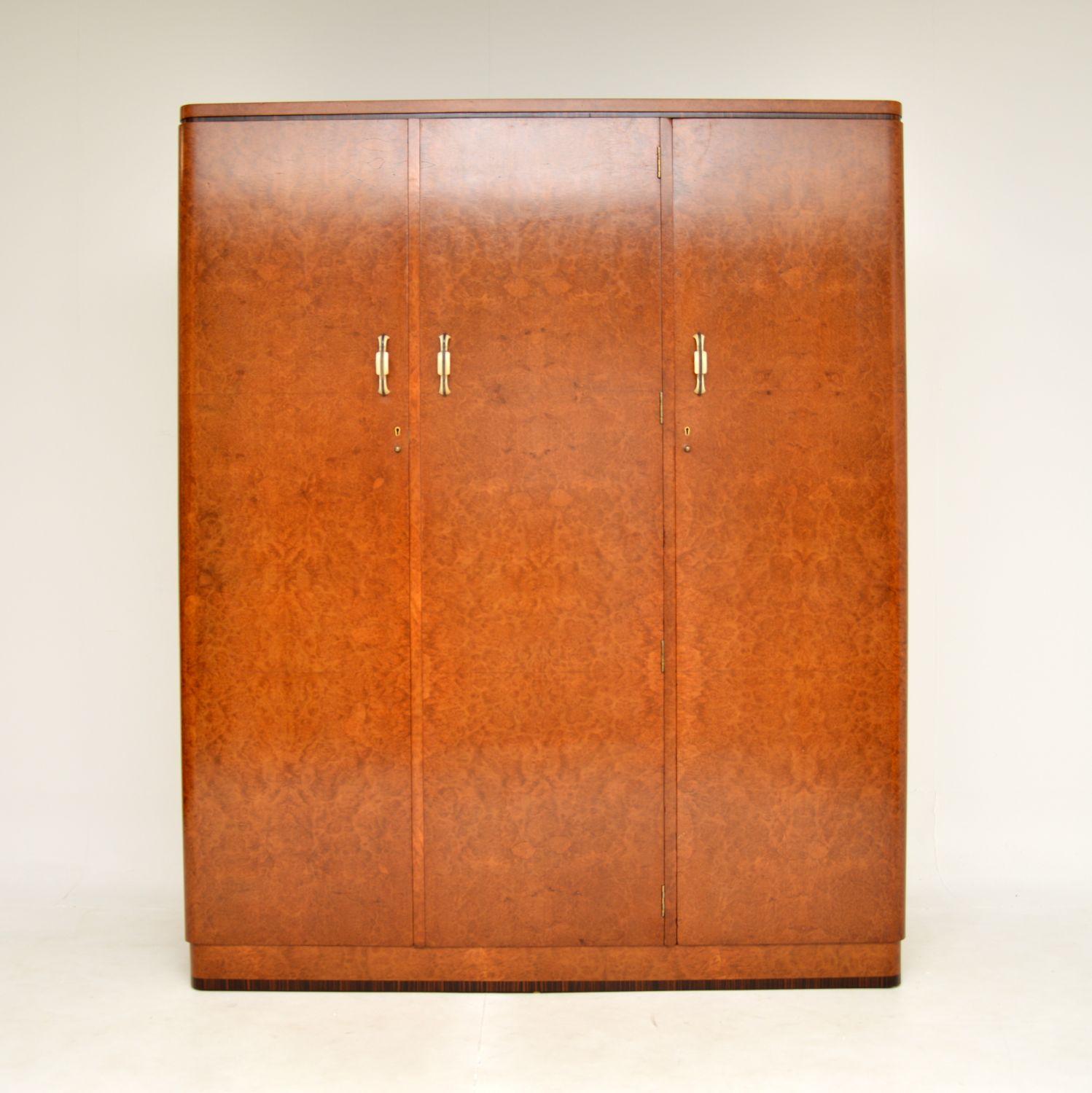 A stunning original Art Deco period burr walnut wardrobe. This was made in England, it dates from the 1930’s.

It is a great size and is of exceptional quality. There are amazing burr walnut grain patterns throughout, with rosewood banding on the