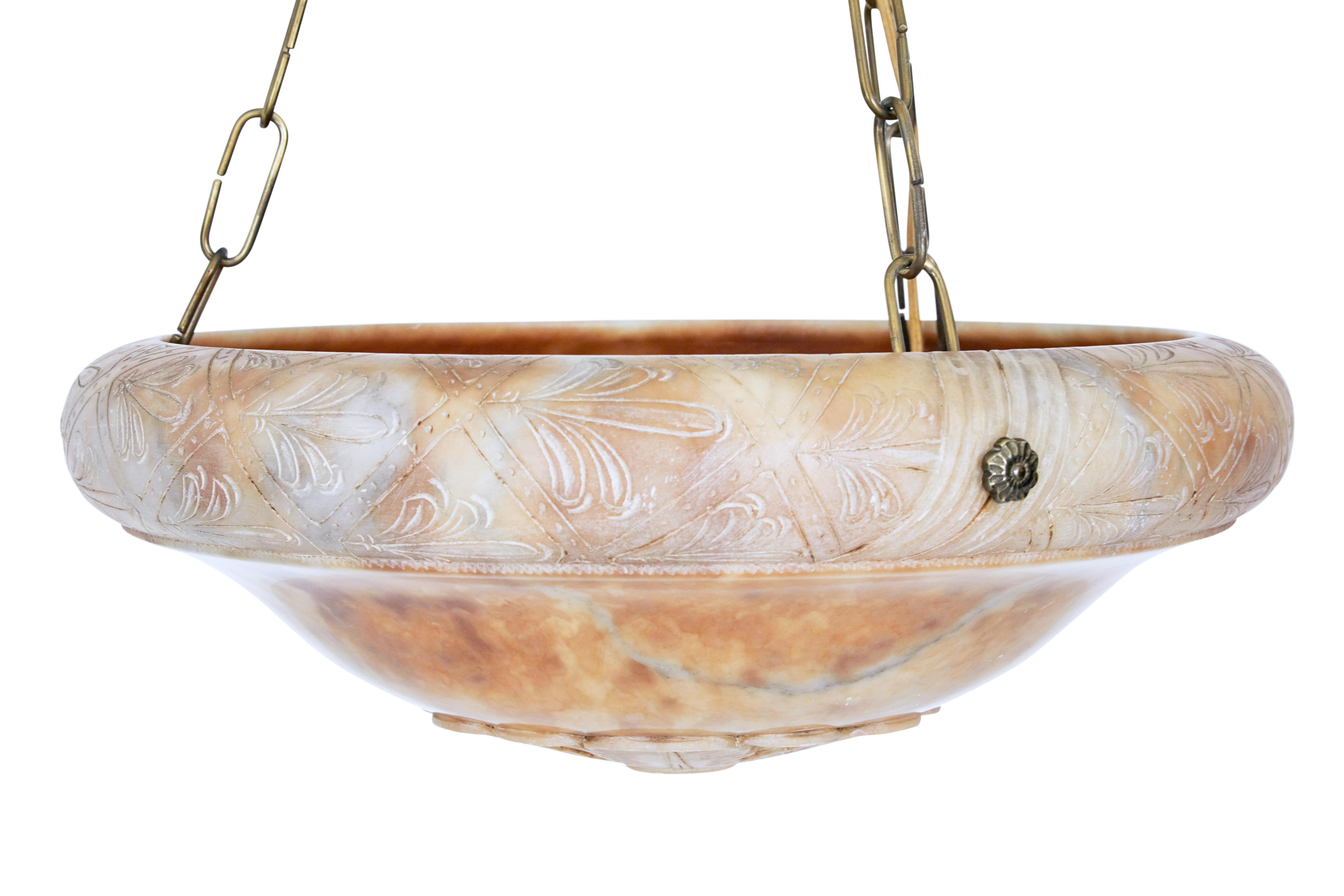 Beautiful carved alabaster chandelier, circa 1930.

Circular alabaster bowl with intricately carved edge and carved flower to the base of the bowl. Supported by 3 brass chains which lead up to a matching alabaster ceiling rose.

Fitted with 3
