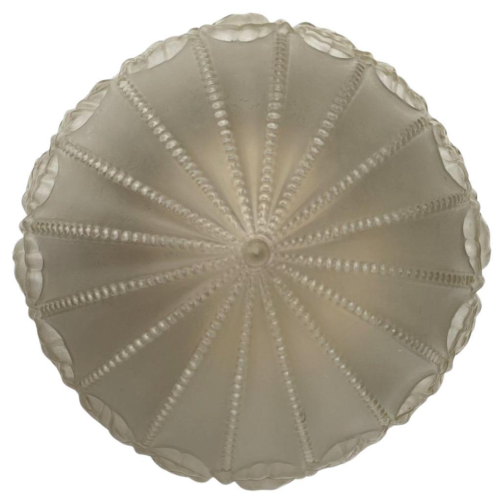 Beautiful 1930s English Art Deco ceiling light in molded pressed glass. The globe is decorated with stylized  embossed rose patterns developed on the skirt of the shade, tinted in sepia satin glass. The chrome gallery is plated brass with three