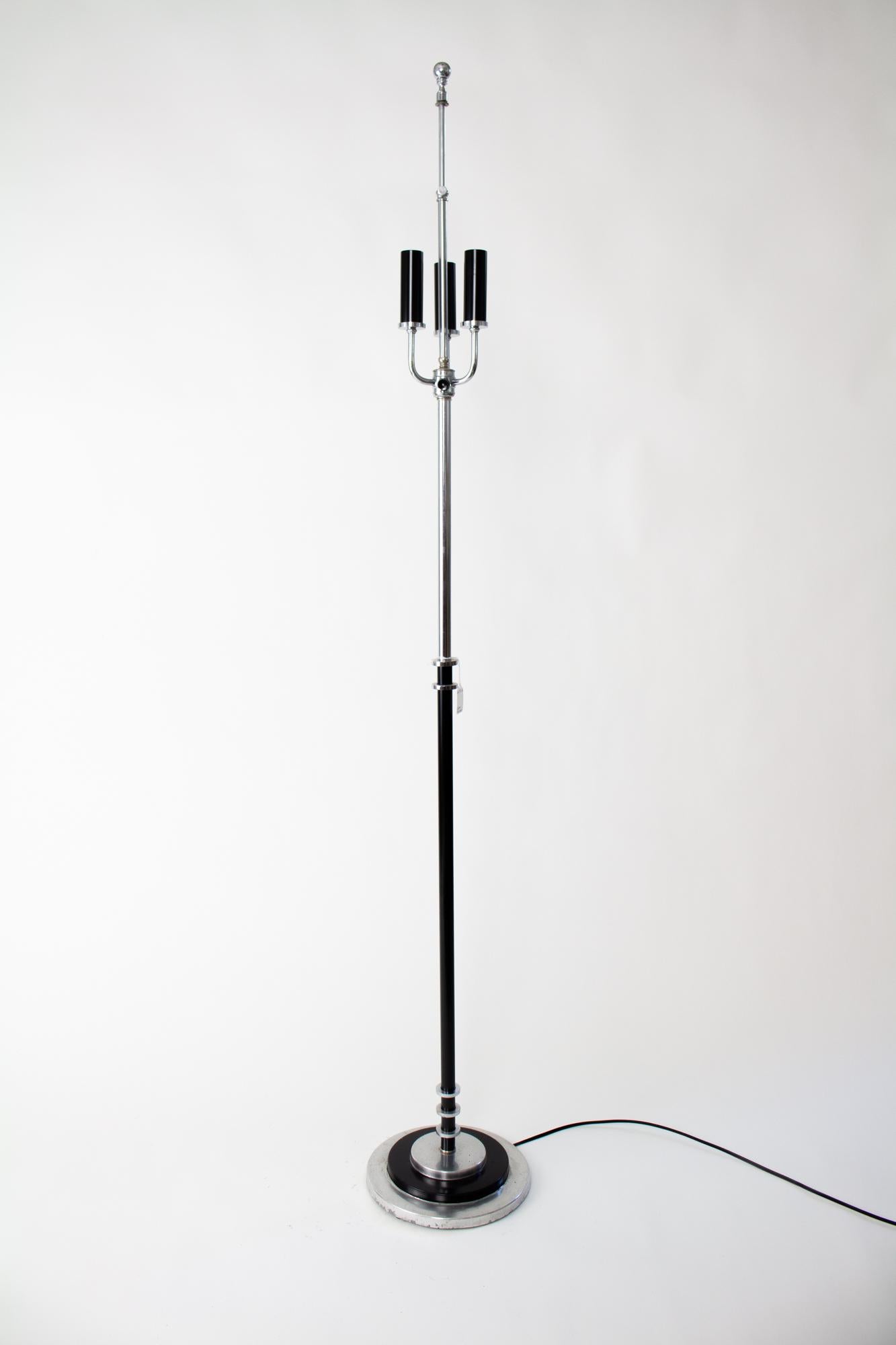 Early 20th Century art deco chrome and black floor lamp with string lampshade. Art Deco modernist styling in a silver and black floor lamp. Metals are a combination of chrome plated and aluminum. Three candle lights, with standard base black