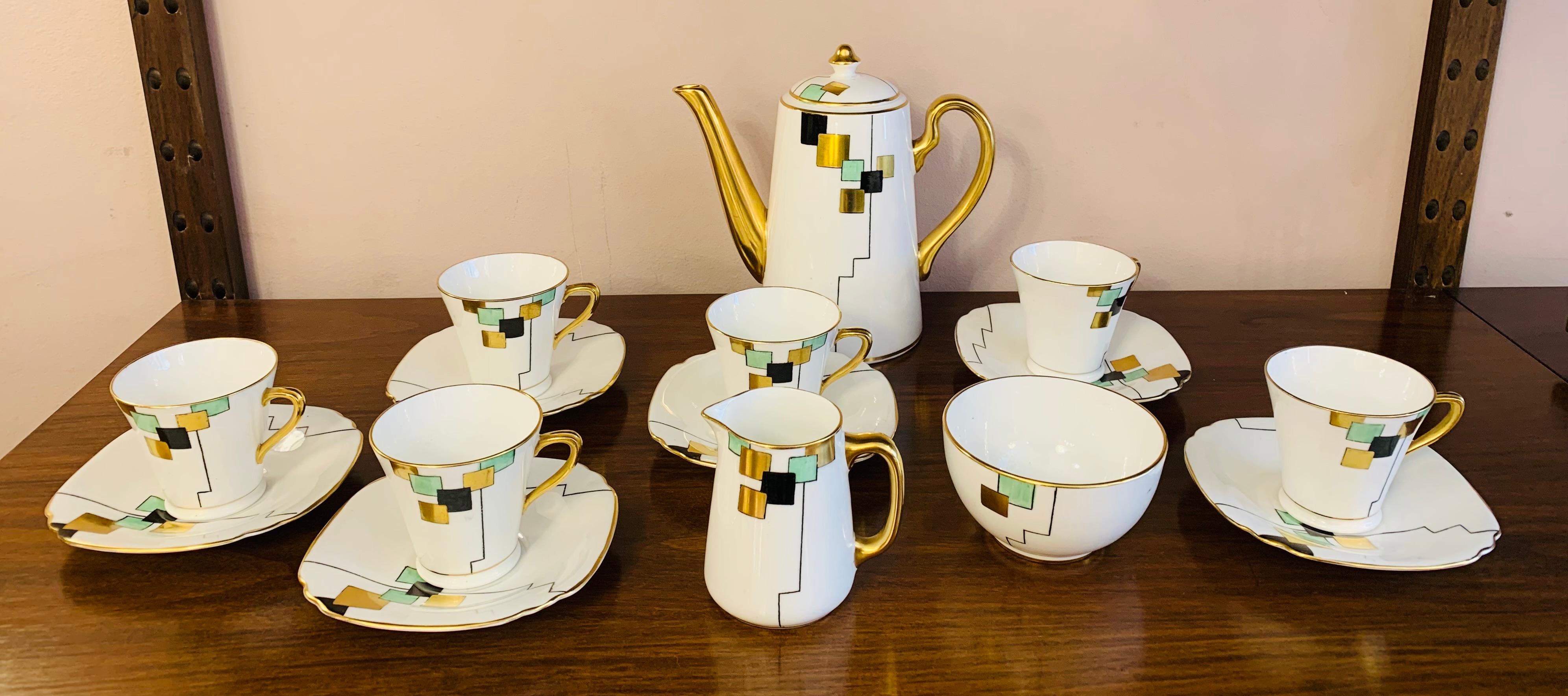 An unusual Art Deco coffee set comprising of: 6 cups with saucers. 1 coffee pot.  1 cream jug and 1 sugar bowl.

Manufactured and stamped on the bottom of each piece - Sadler.  Rode Heath. Stoke on Trent. ENGLAND. Hand painted with a cubist pattern