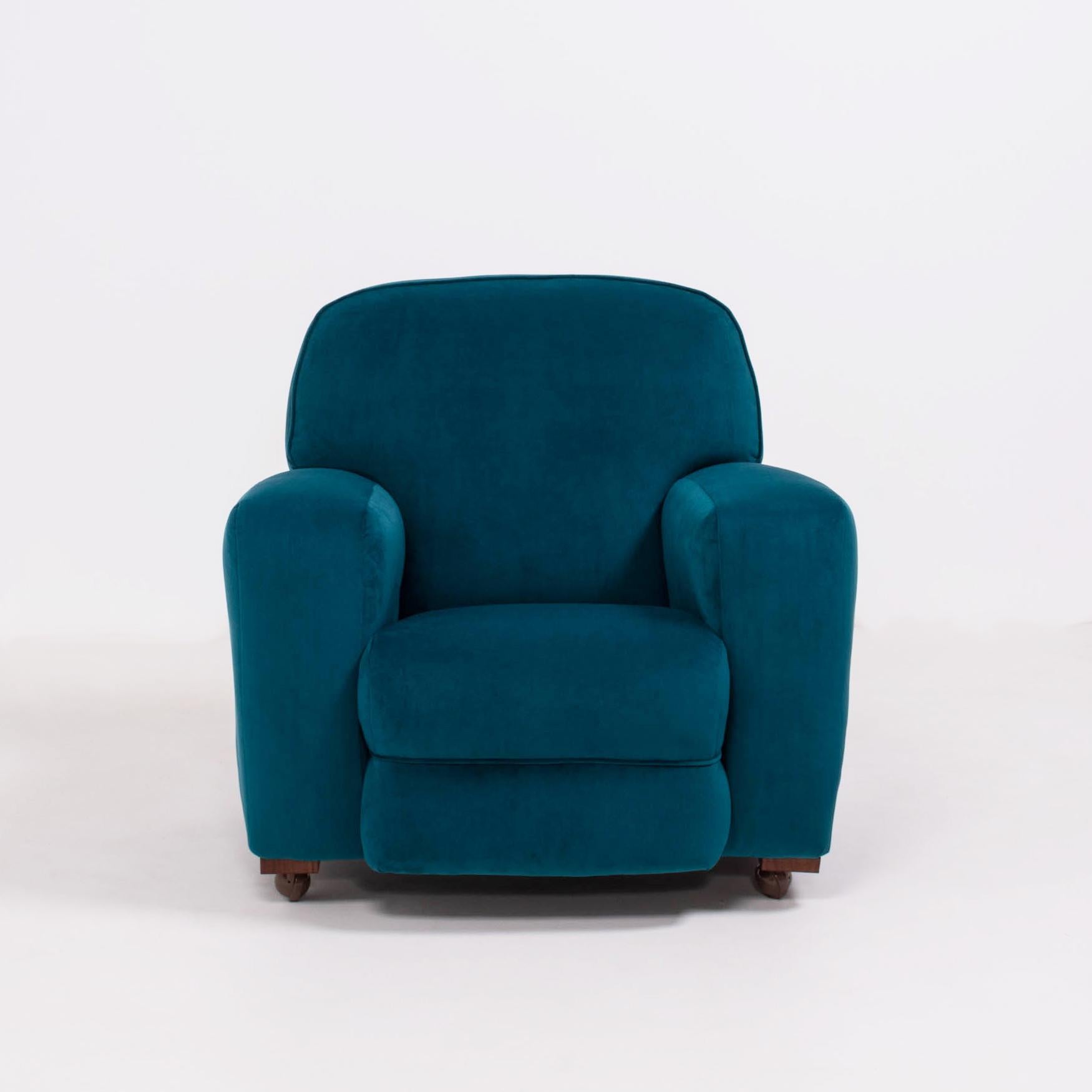 This original 1930s Art Deco curved armchair has been newly reupholstered in plush blue teal velvet, and features wide armrests and a high, comfortable back.

The blocks and castor wheels have been replaced.

Measurements: 103cm (W) x 93cm (H) x
